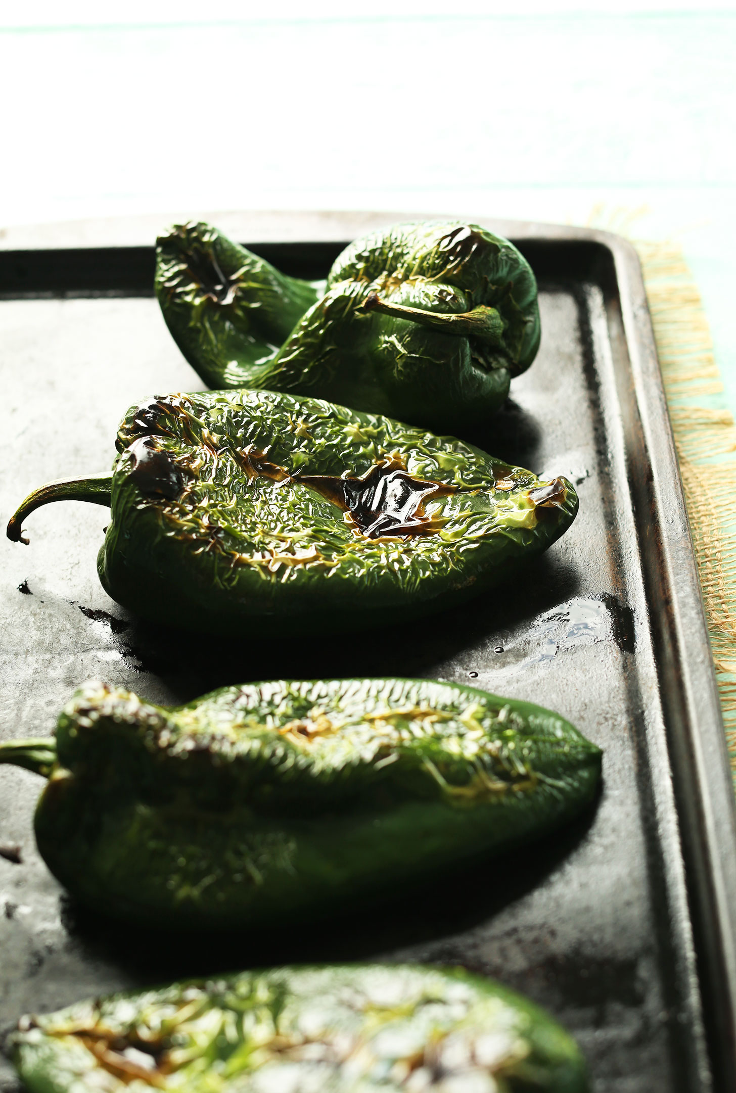 Baking sheet of freshly roasted poblano peppers