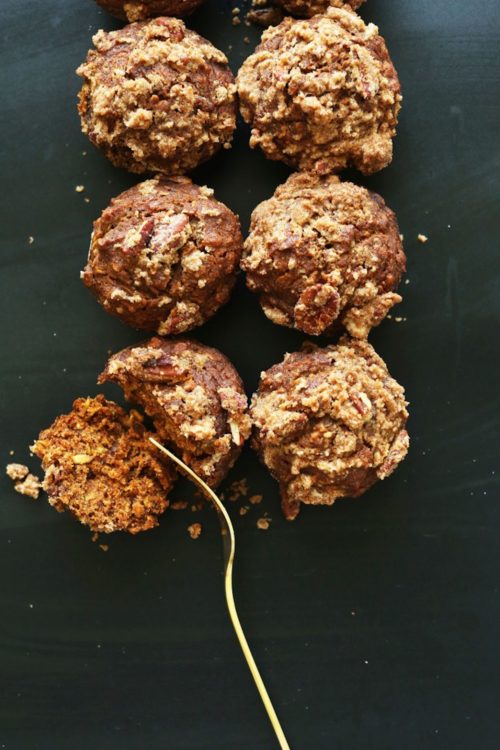 Cutting into a Pumpkin Spice Muffin with Pecan Crumble Topping for the perfect fall vegan dessert