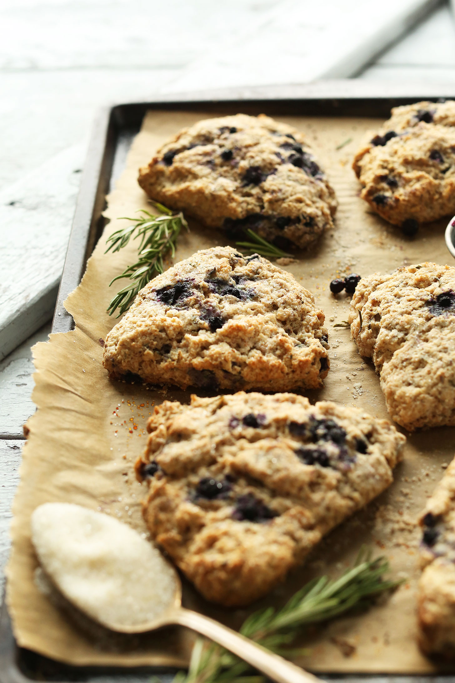 Parchment-lined baking sheet with Rosemary Blueberry Scones for a delicious vegan breakfast