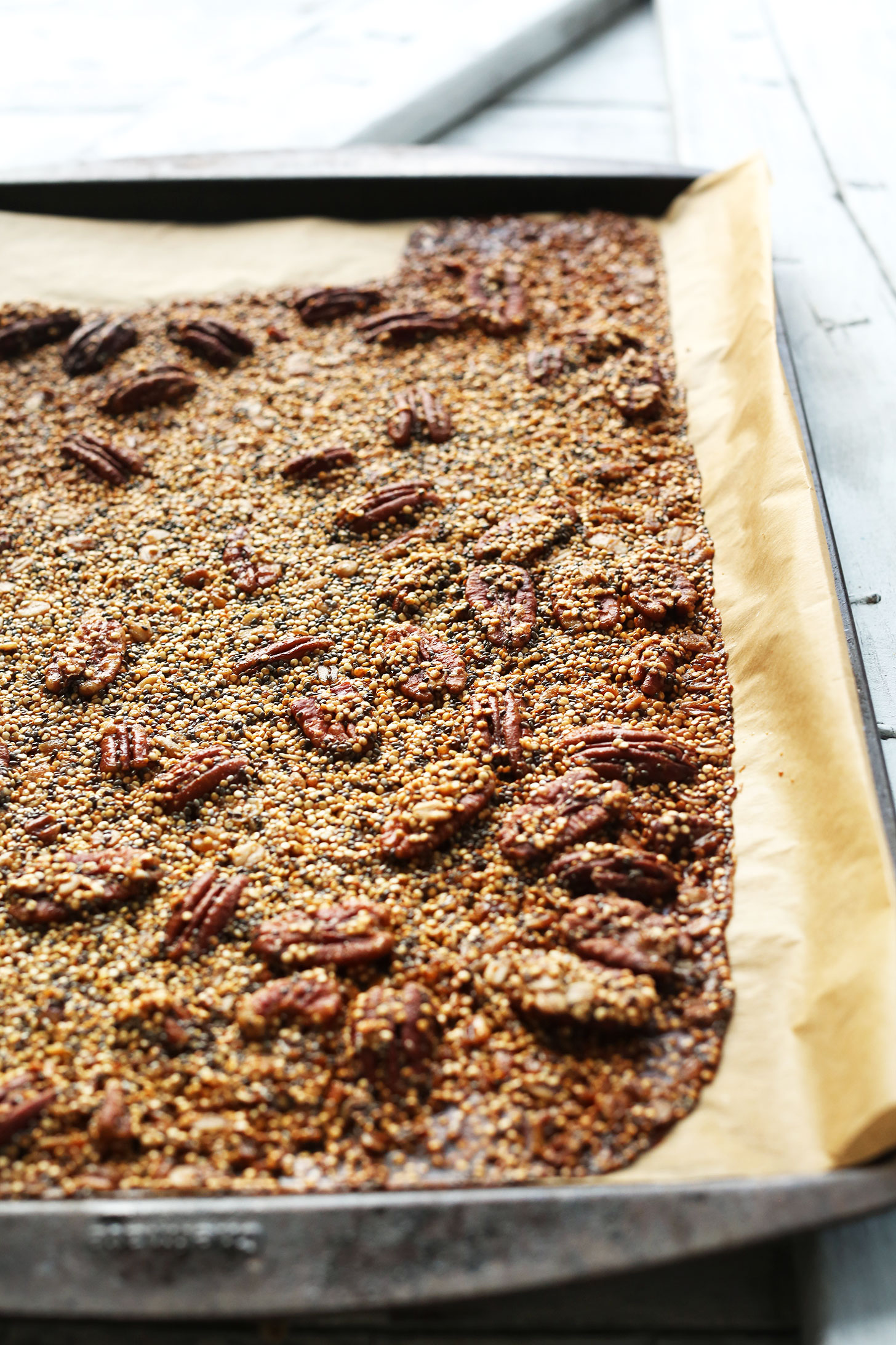 Parchment-lined baking sheet filled with our healthy homemade Quinoa Brittle recipe