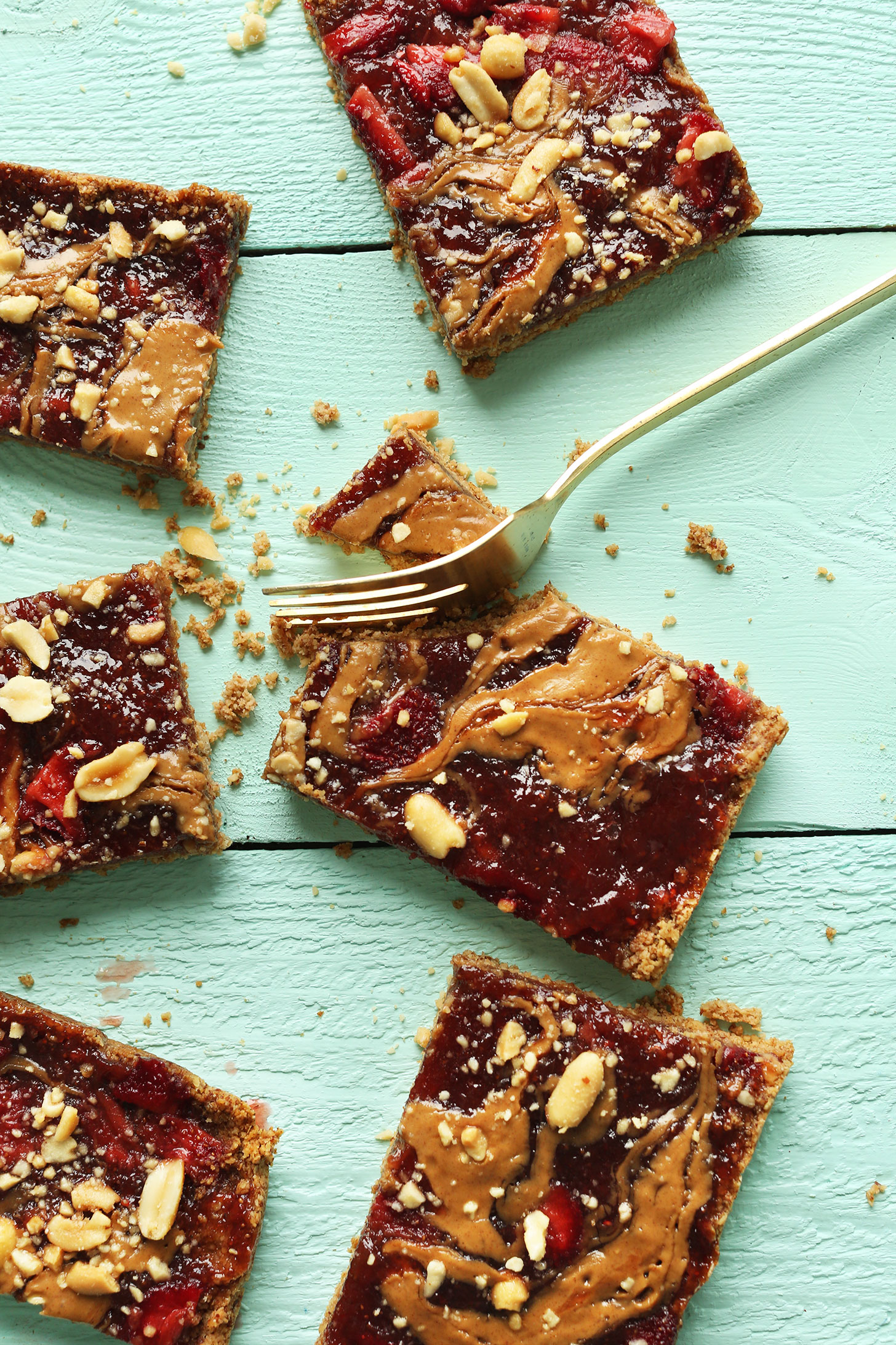 Grabbing a bite of a vegan gluten-free PB&J Oat Bar for a healthy snack