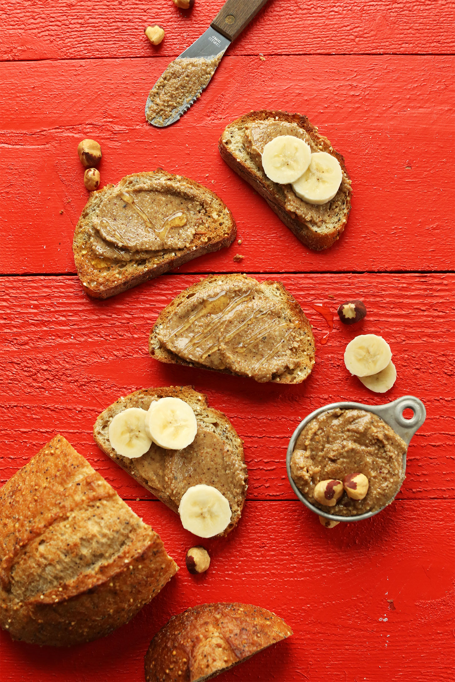 Sliced gluten-free bread topped with creamy homemade hazelnuts butter, honey, and peanut butter