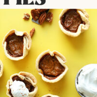 Overhead photo of a batch of our mini vegan pumpkin pies with text that says naturally sweetened