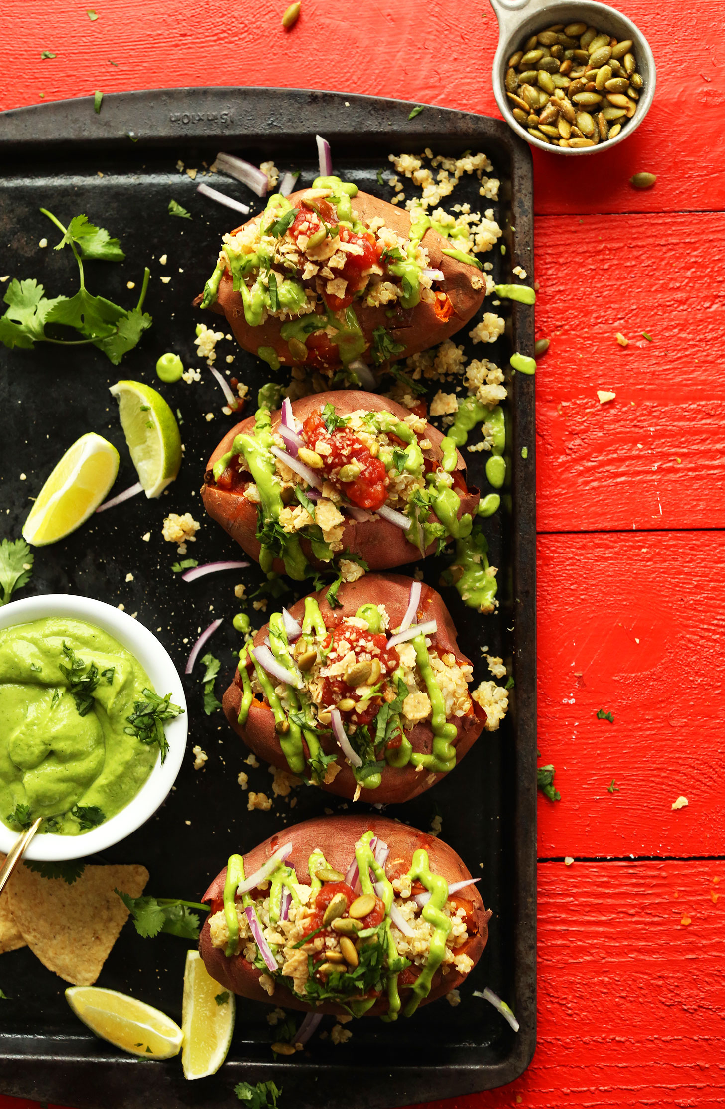 Tray of Quinoa Stuffed Sweet Potatoes with healthy crunchy toppings for a filling plant-based meal