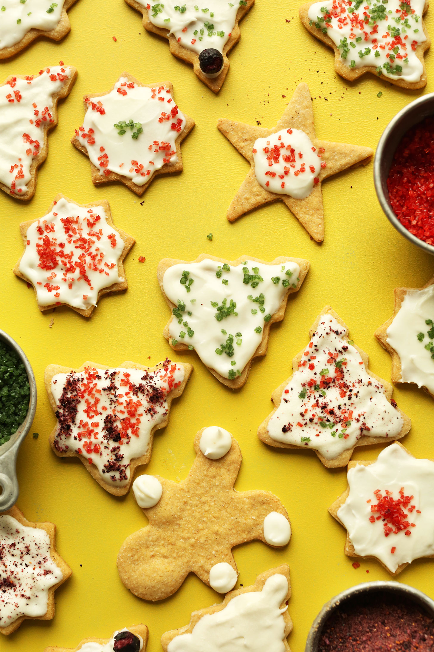 Array of gluten-free vegan sugar cookies on a yellow background