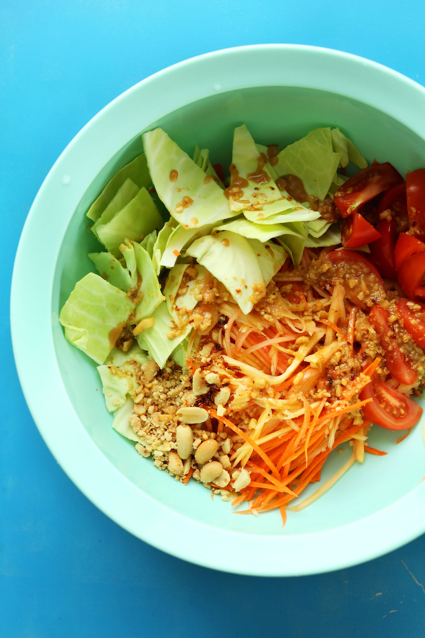 Mixing bowl with ingredients for our Easy Thai Papaya Salad for a healthy and refreshing dish