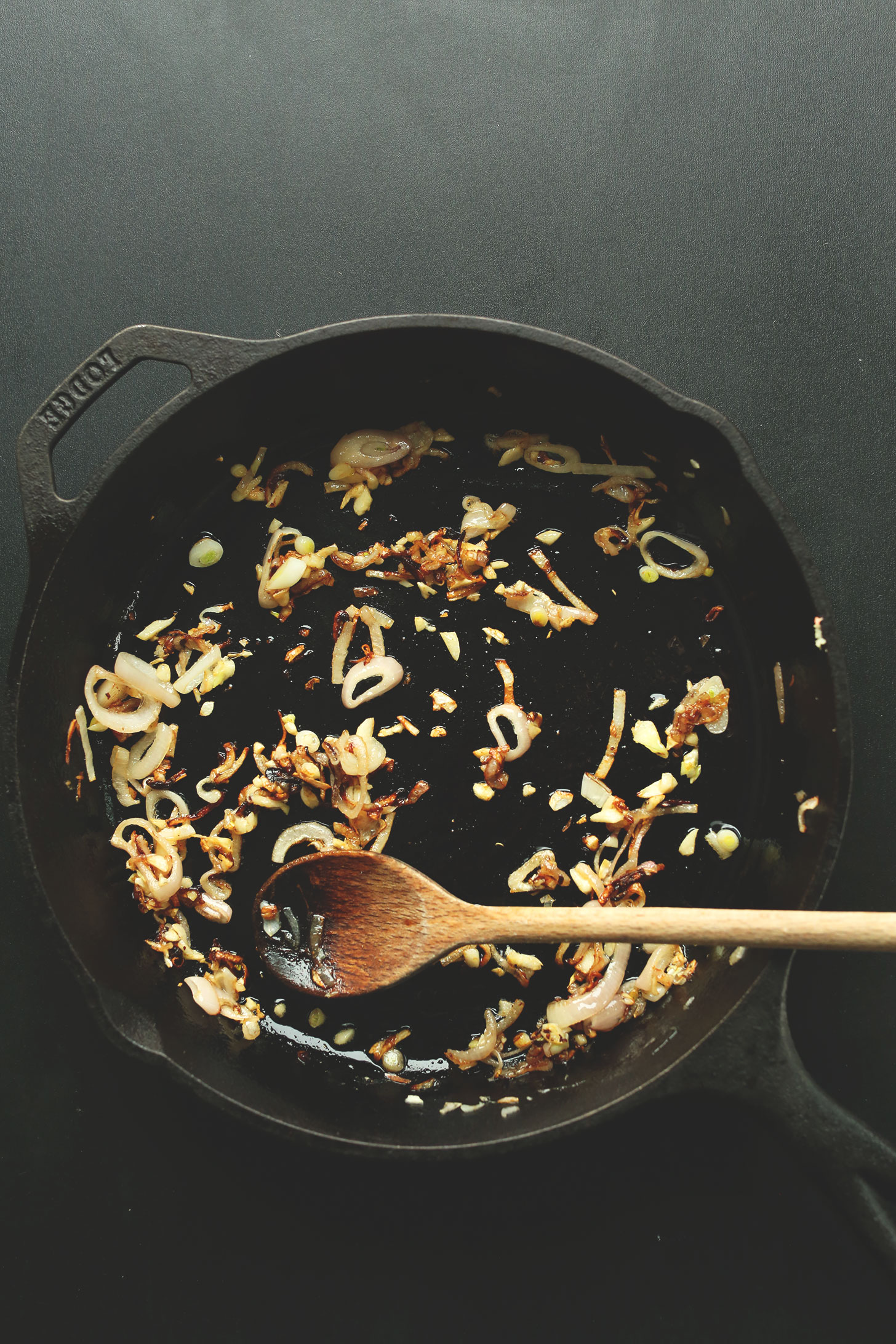Cooking shallot in a cast-iron skillet for delicious Mediterranean Lentil Dip