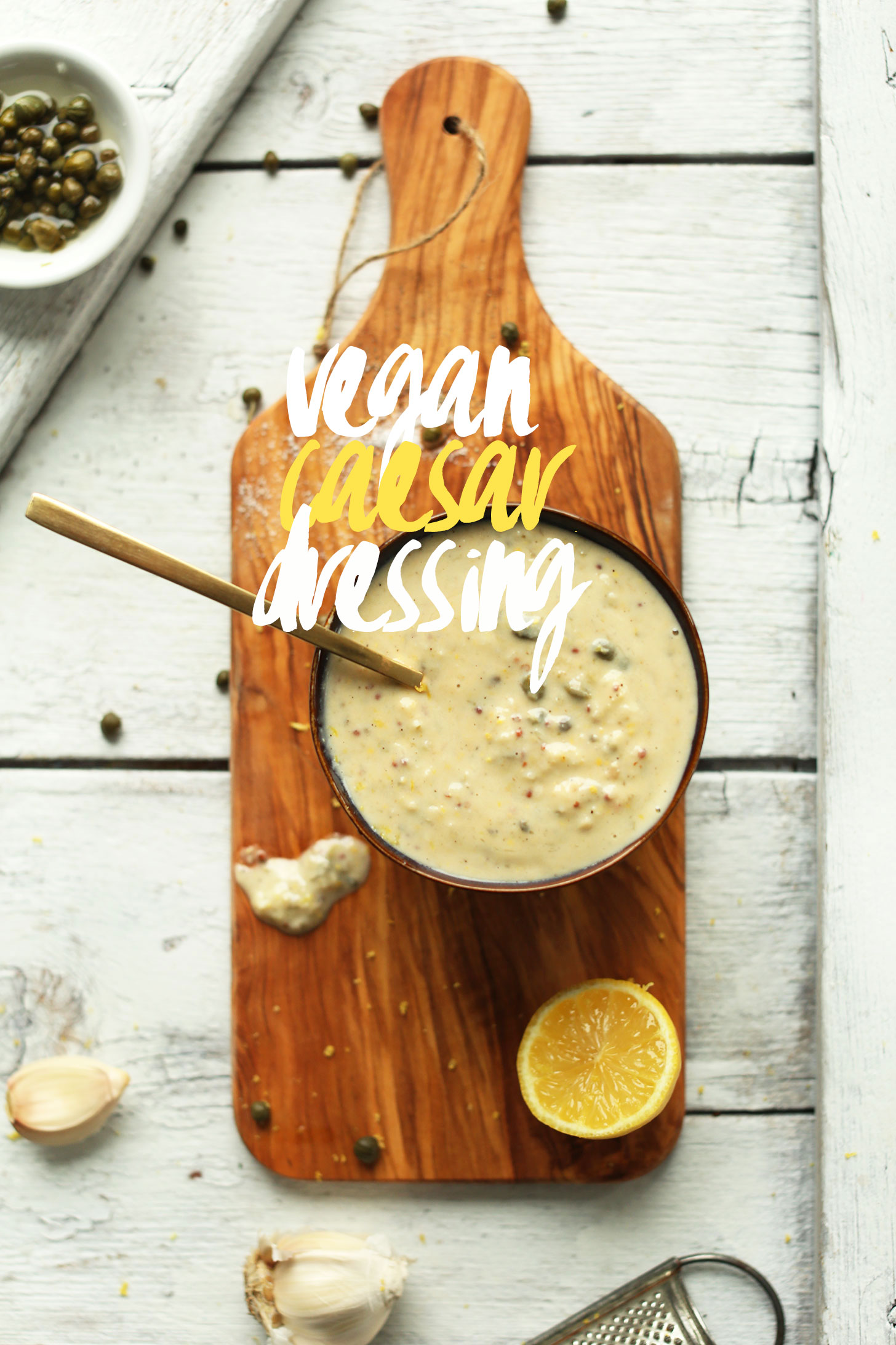 Bowl of gluten-free vegan caesar dressing on a wood cutting board