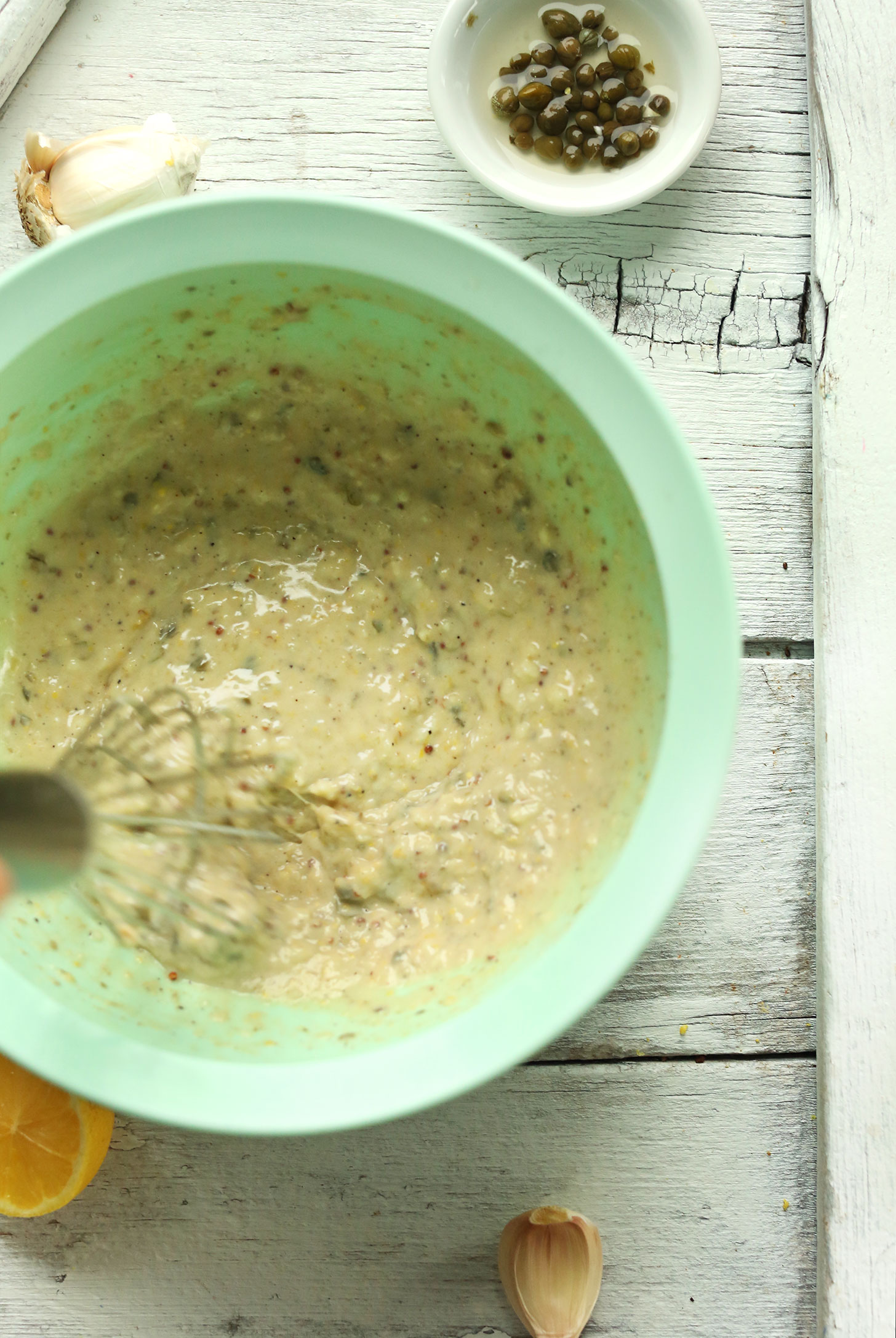 Whisking together ingredients for simple homemade vegan caesar dressing