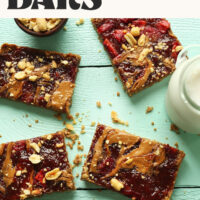 Peanut Butter and Jelly Snack Bars on a blue background with text above that says 8 simple ingredients