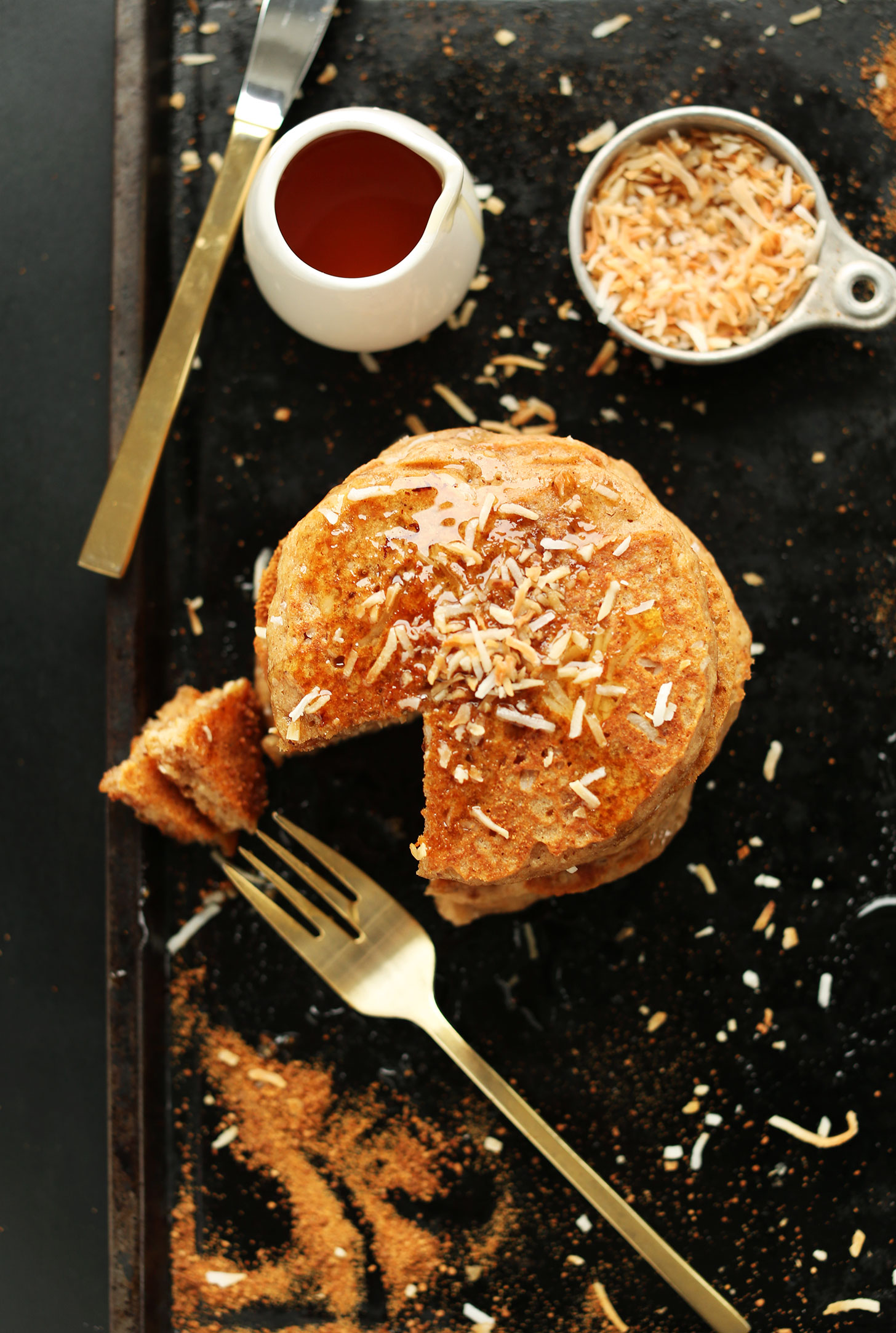 Grabbing a bite of our Vegan Toasted Coconut Pancakes with extra maple syrup and toasted coconut