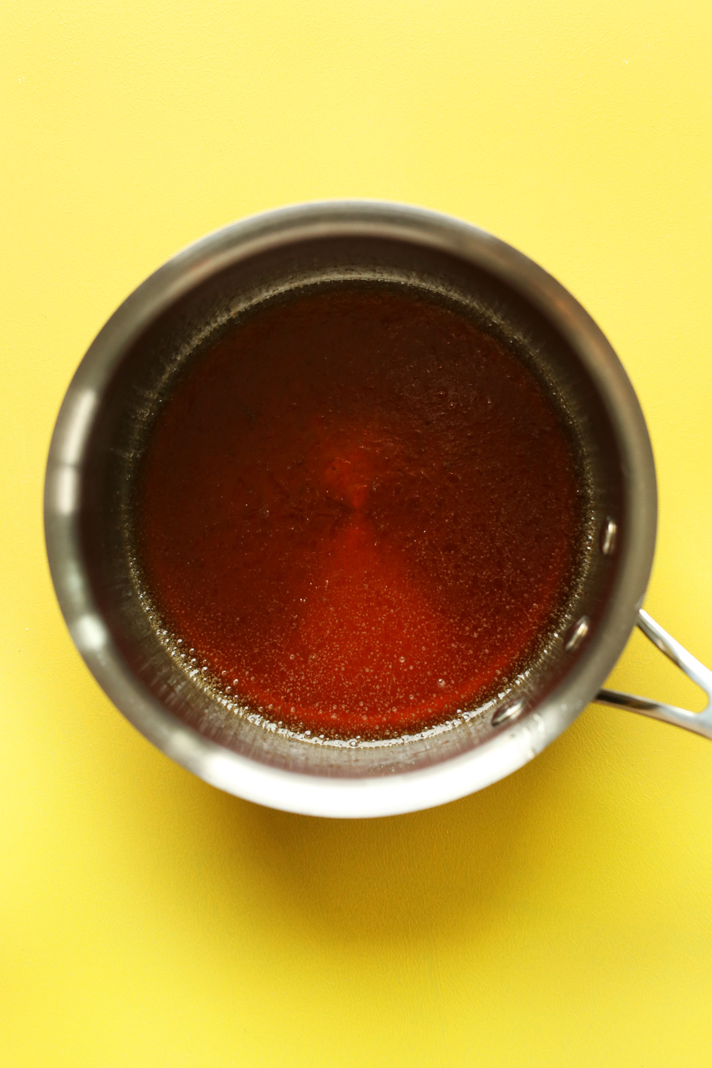 Melted coconut oil, maple syrup, and vanilla for making our homemade Coconut Granola recipe