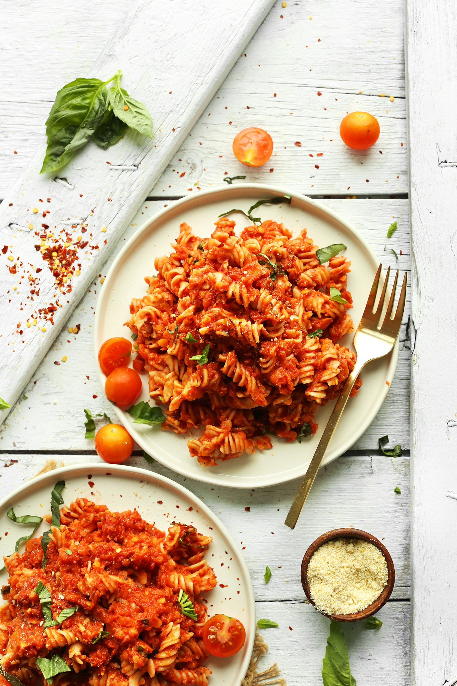 Two plates of our Spicy Red Pasta with Lentils and GF Pasta for a plant-based dinner