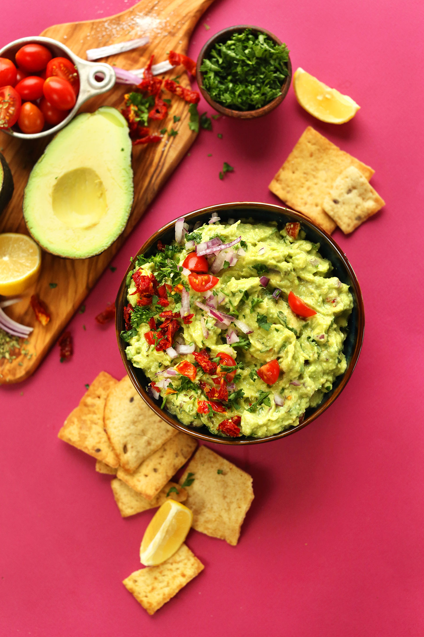 Bowl of vegan Greek-inspired Guacamole with crackers for dipping