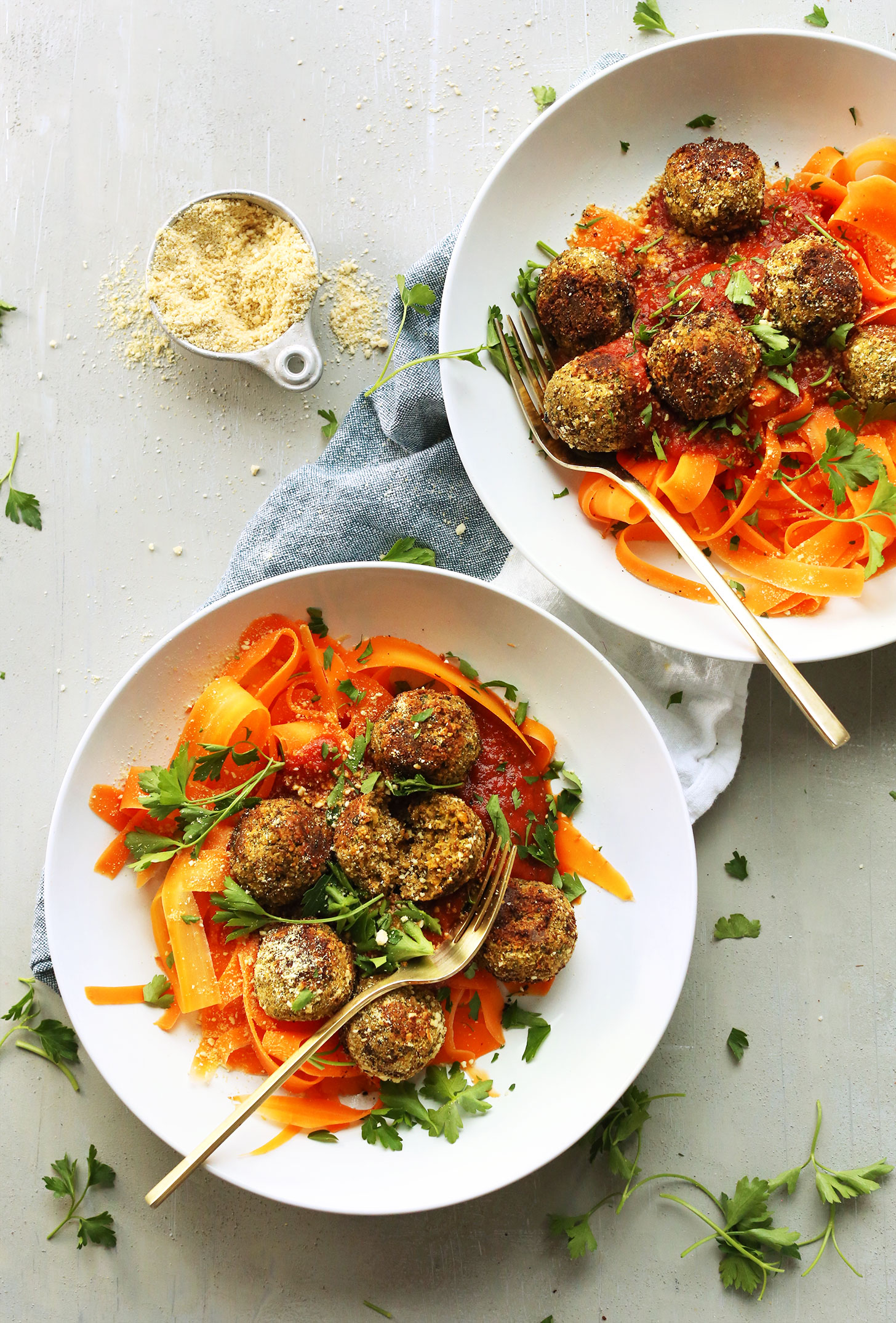 Dinner bowls filled with carrot noodles topped with our easy vegan lentil meatballs recipe