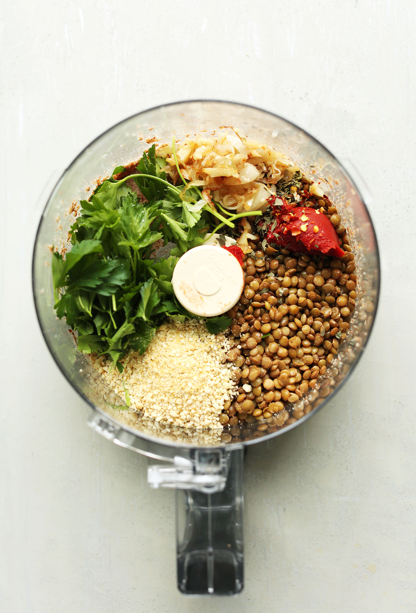 Food processor with ingredients for our protein-packed vegan lentil meatballs recipe