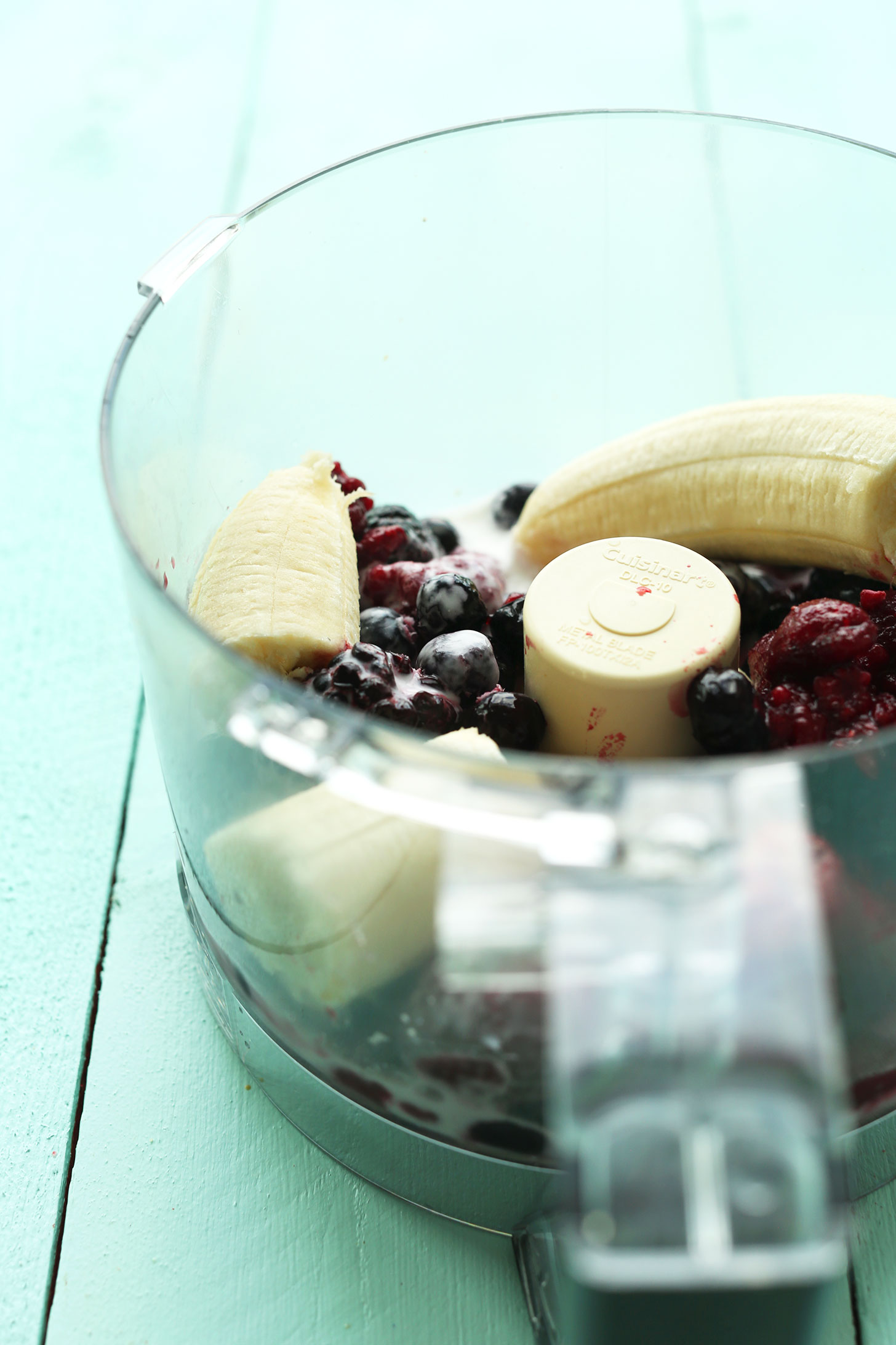 Food processor with ingredients for making our healthy vegan Banana and Hempseed Berry Pudding