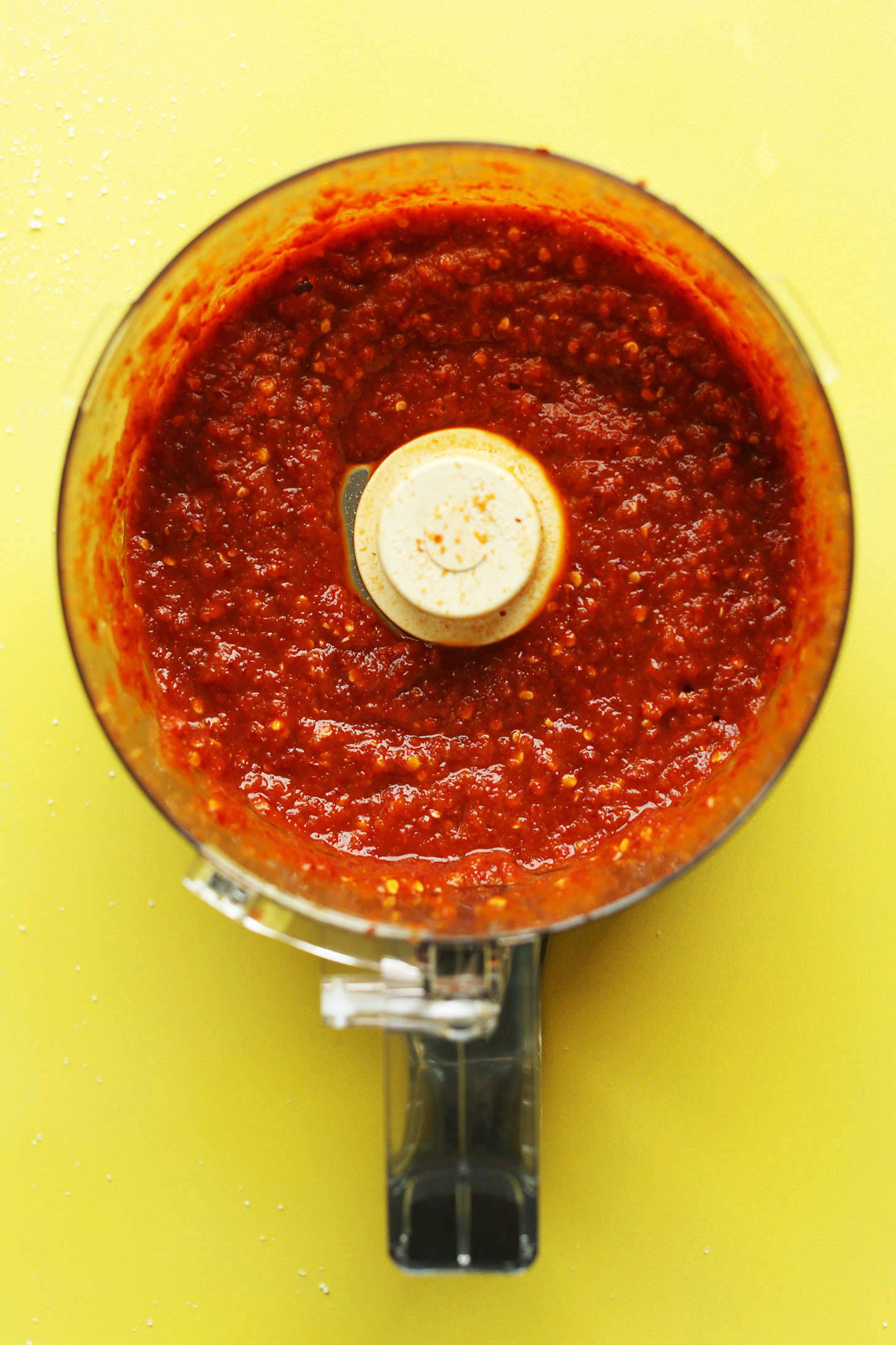 Food processor with freshly blended spices for making our spicy gluten-free vegan kimchi recipe