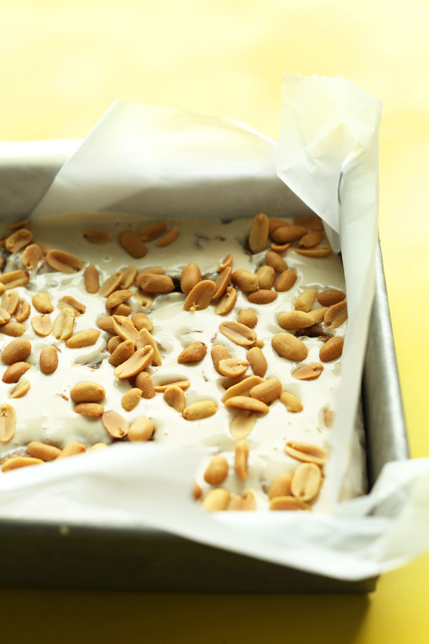 Vegan Snickers Cheesecake with peanuts sprinkled on top