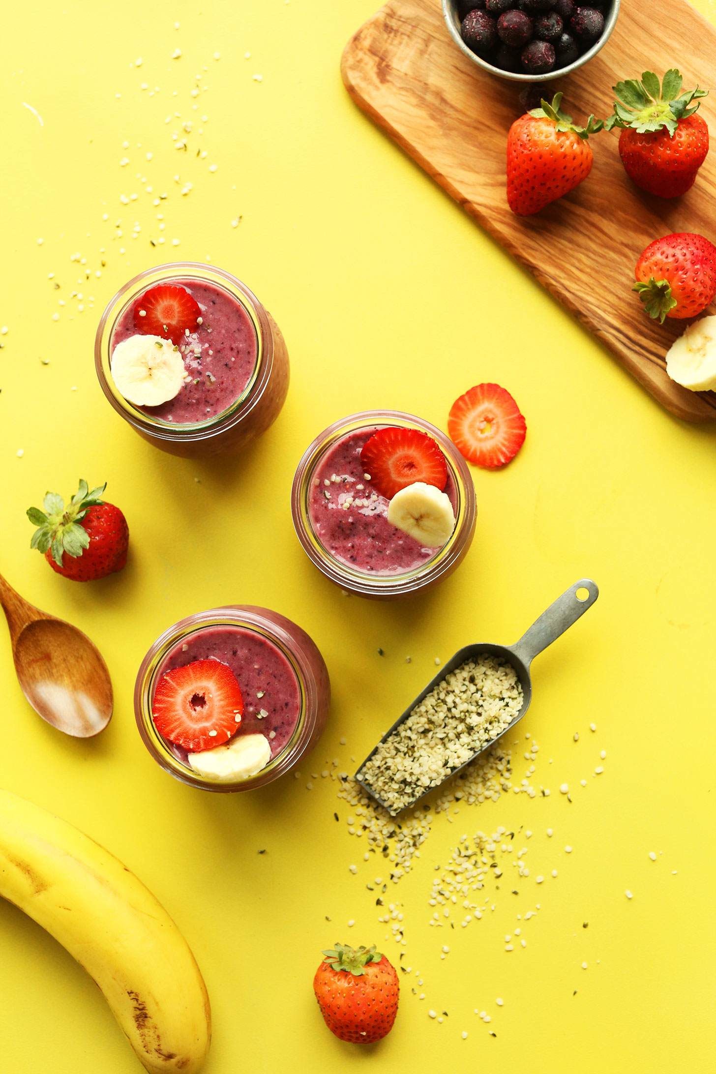 Jars of our Banana and Hempseed Berry Pudding recipe topped with fresh fruit