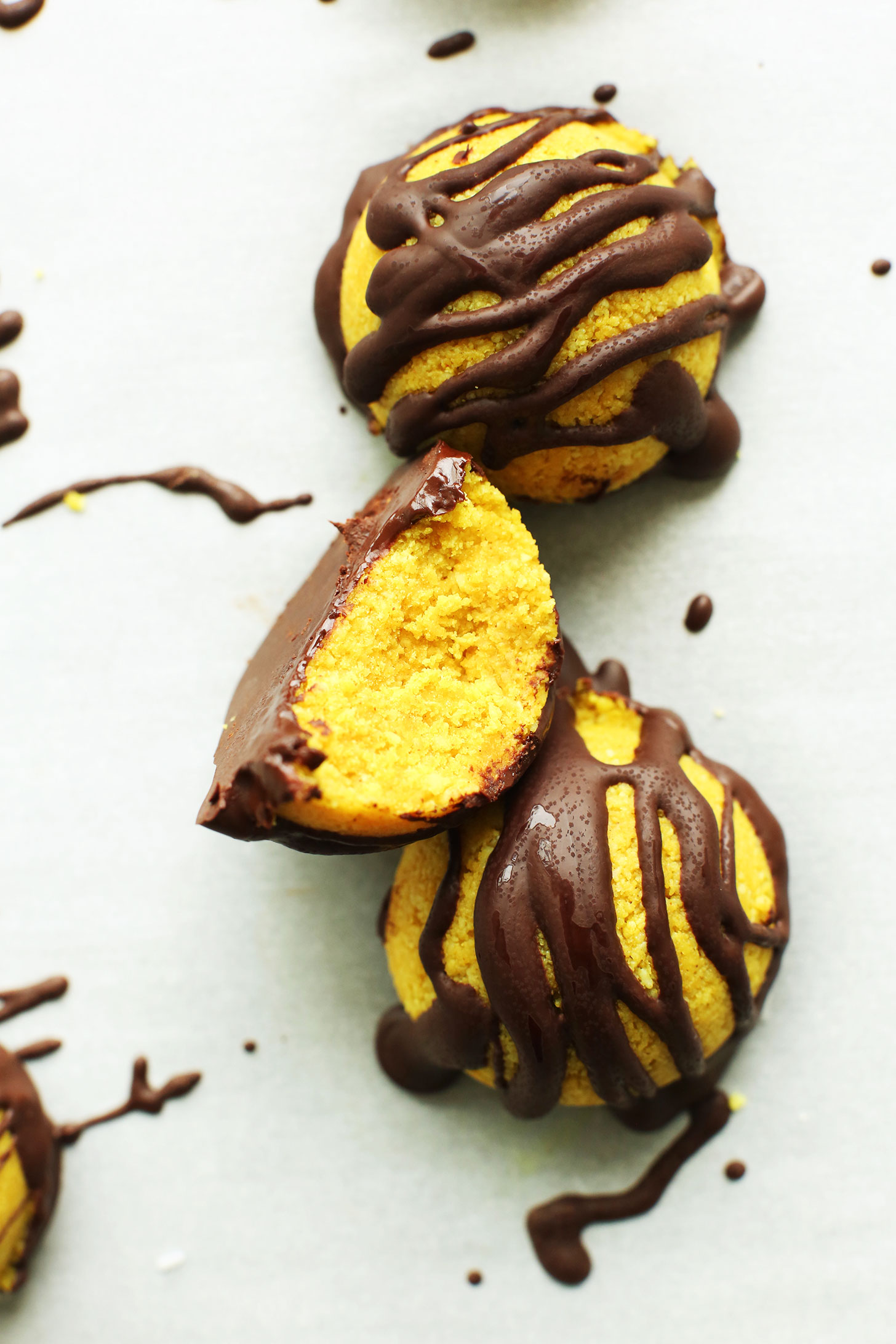 Half eaten Golden Milk Macaroon drizzled with dark chocolate