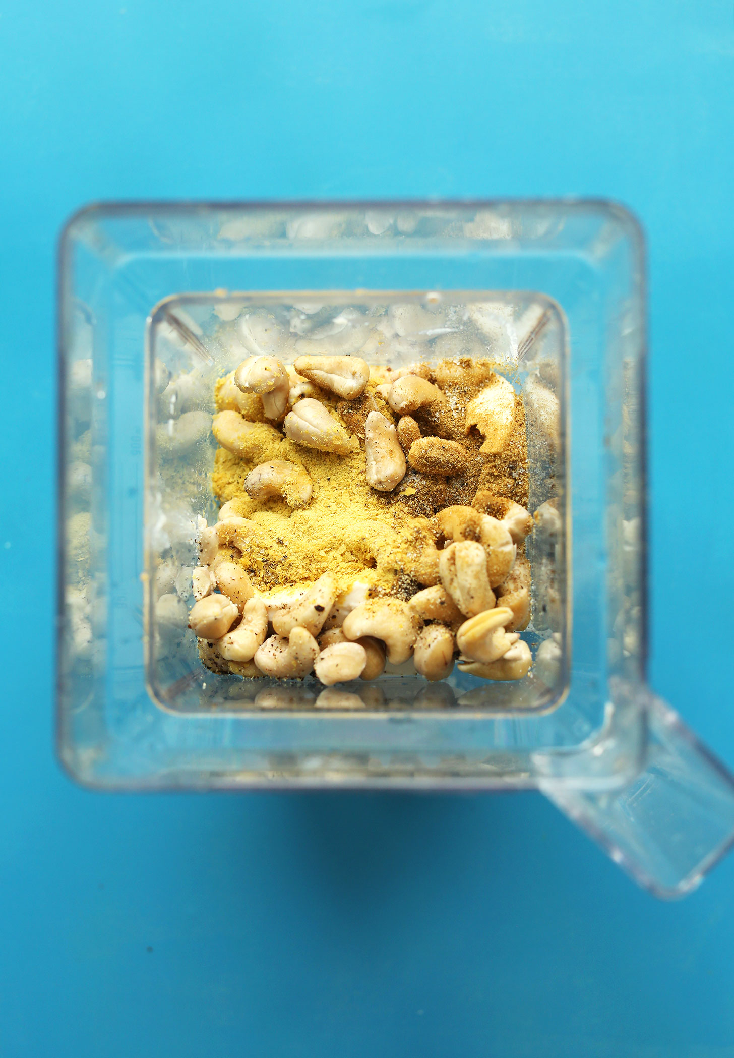 Blender with ingredients for making our spicy Cheesy Vegan Corn Dip for a delicious summer appetizer