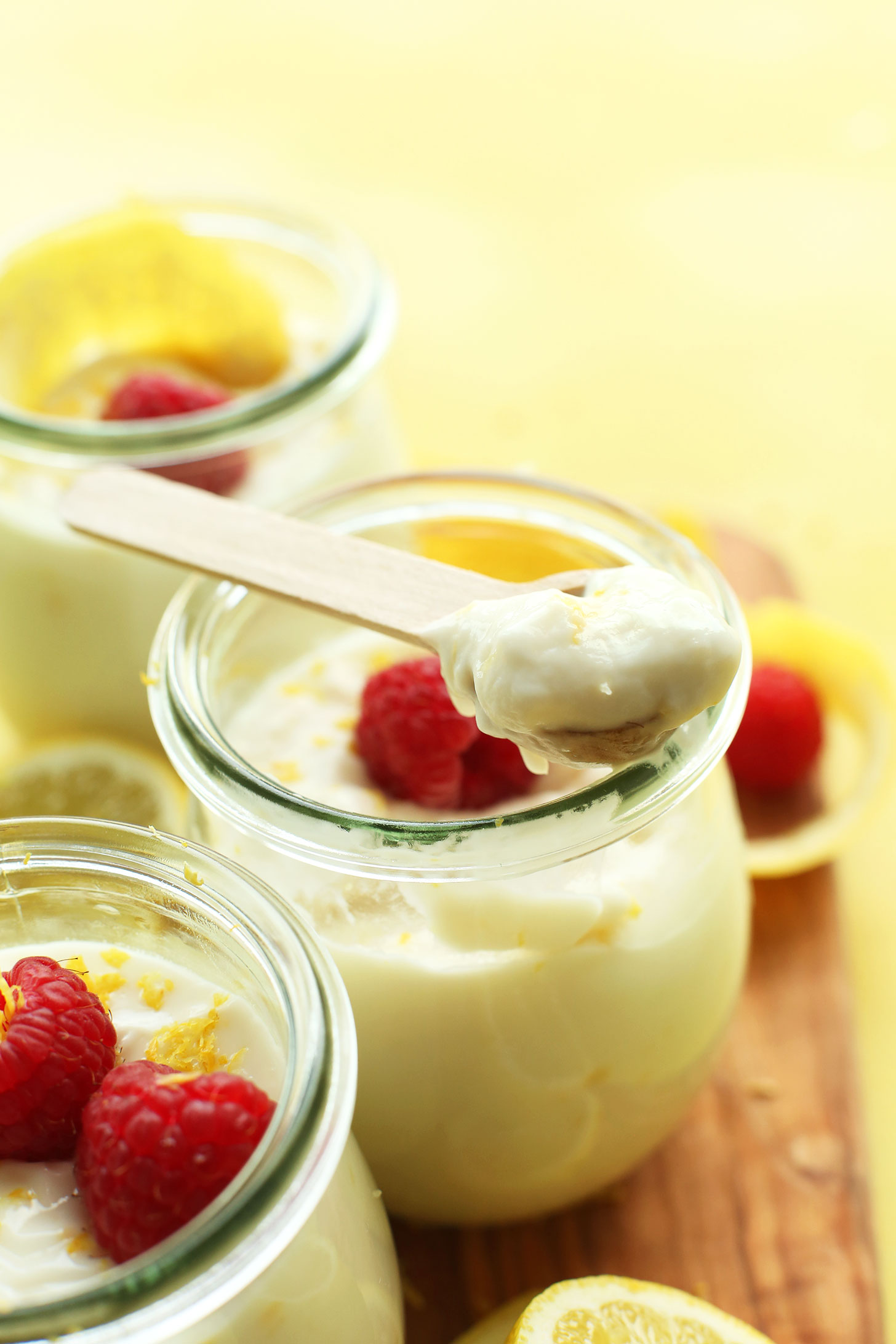Spoonful of vegan lemon curd resting on a jar of this delicious vegan desert