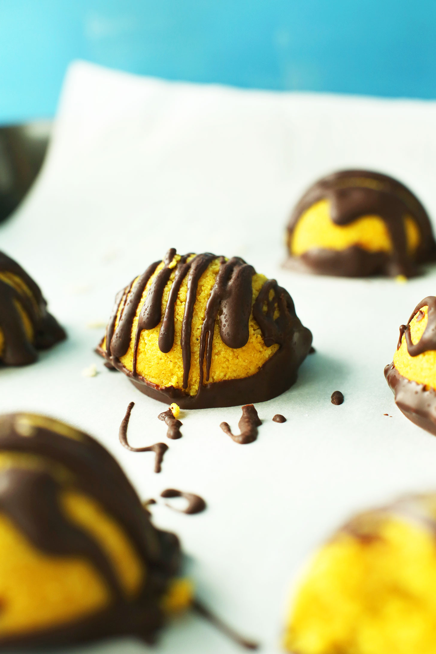 Gluten-free vegan Golden Milk Macaroons drizzled with chocolate sauce