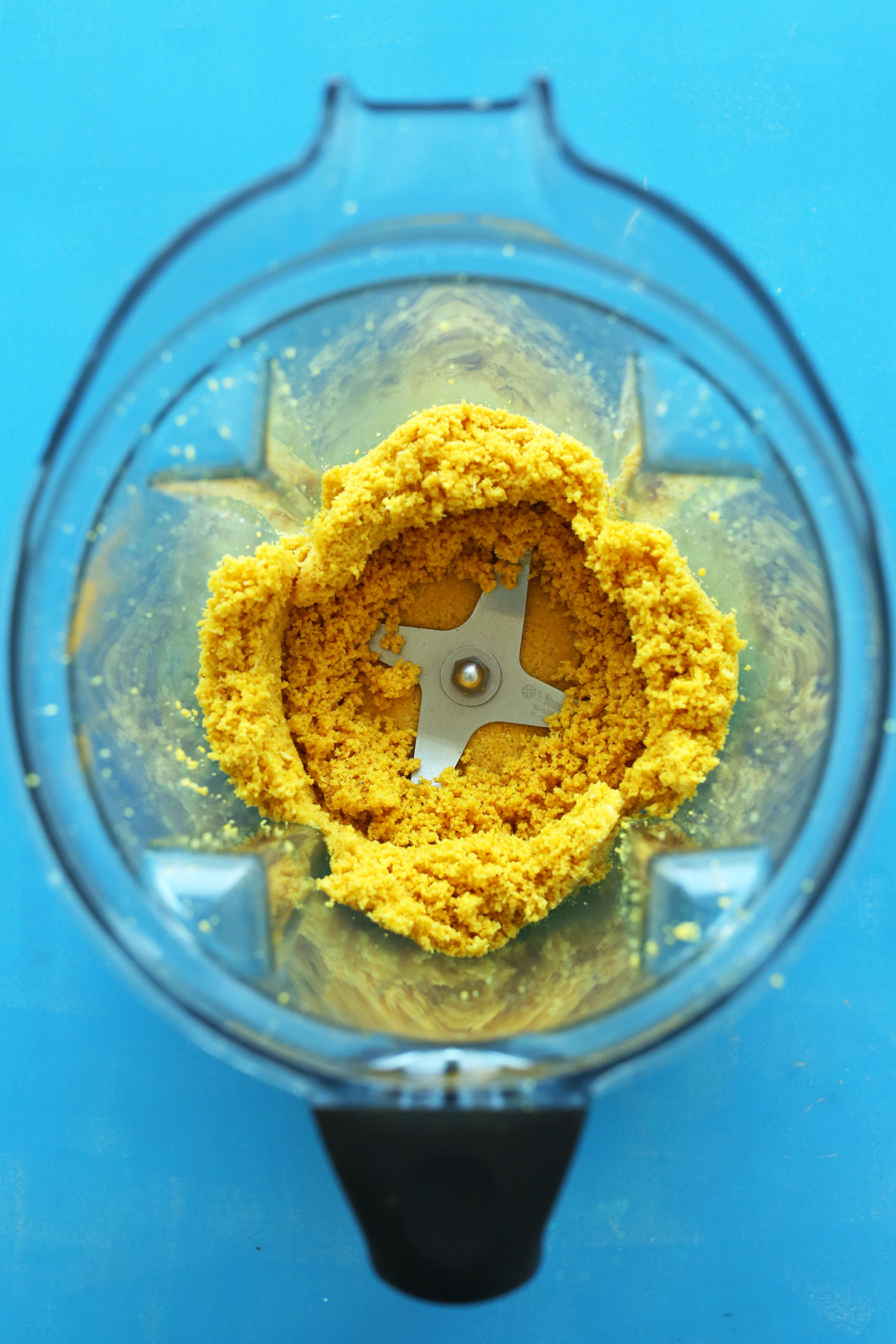 Blender with ingredients for making homemade healthy macaroons with turmeric