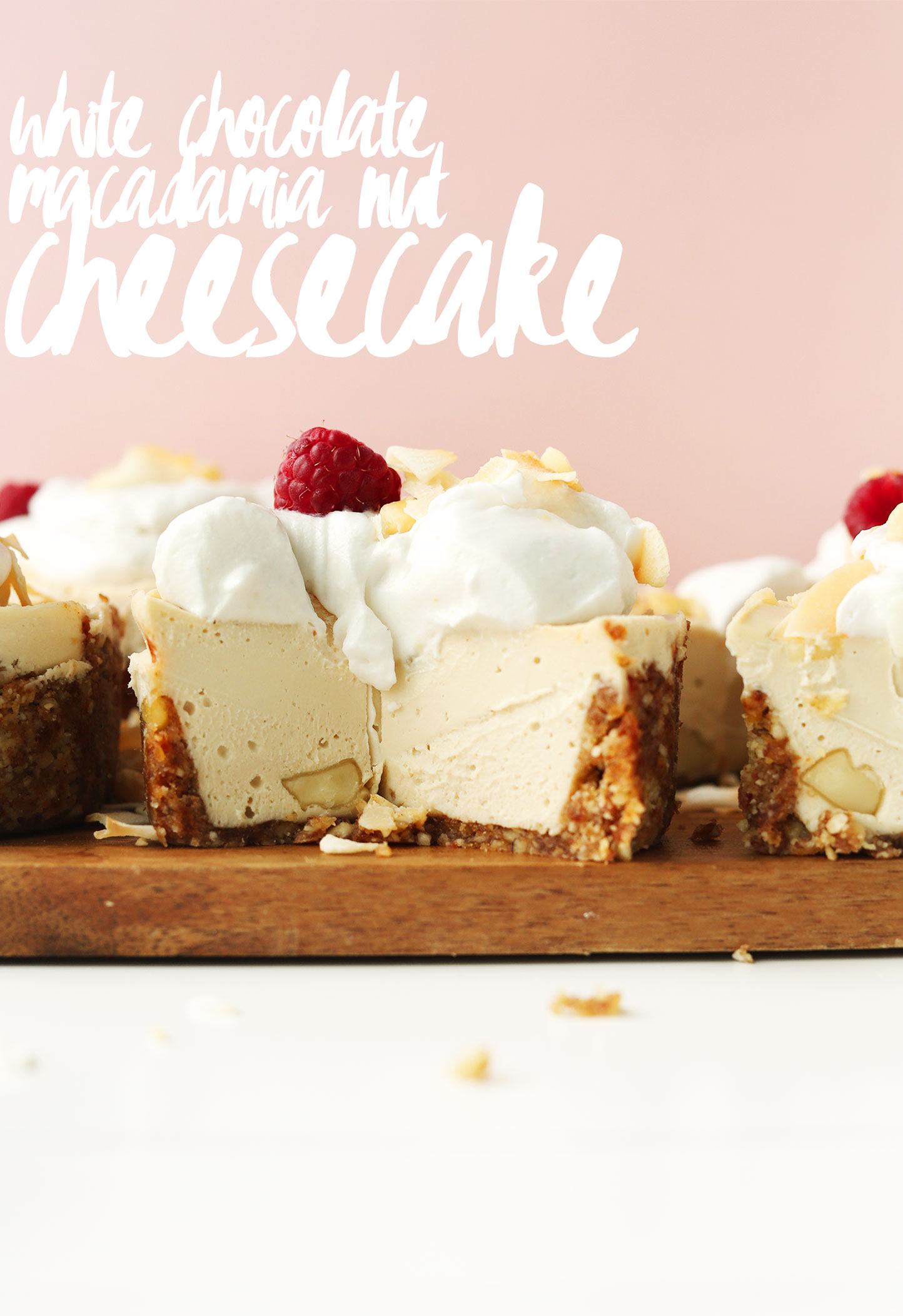 Mini White Chocolate Macadamia Nut Cheesecake topped with coconut whip and a raspberry