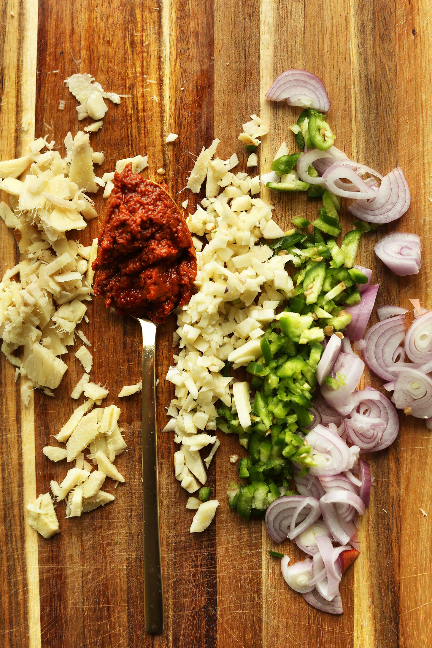 Ginger, garlic, curry paste, serrano, and shallot for making delicious gluten-free vegan Yellow Thai Curry