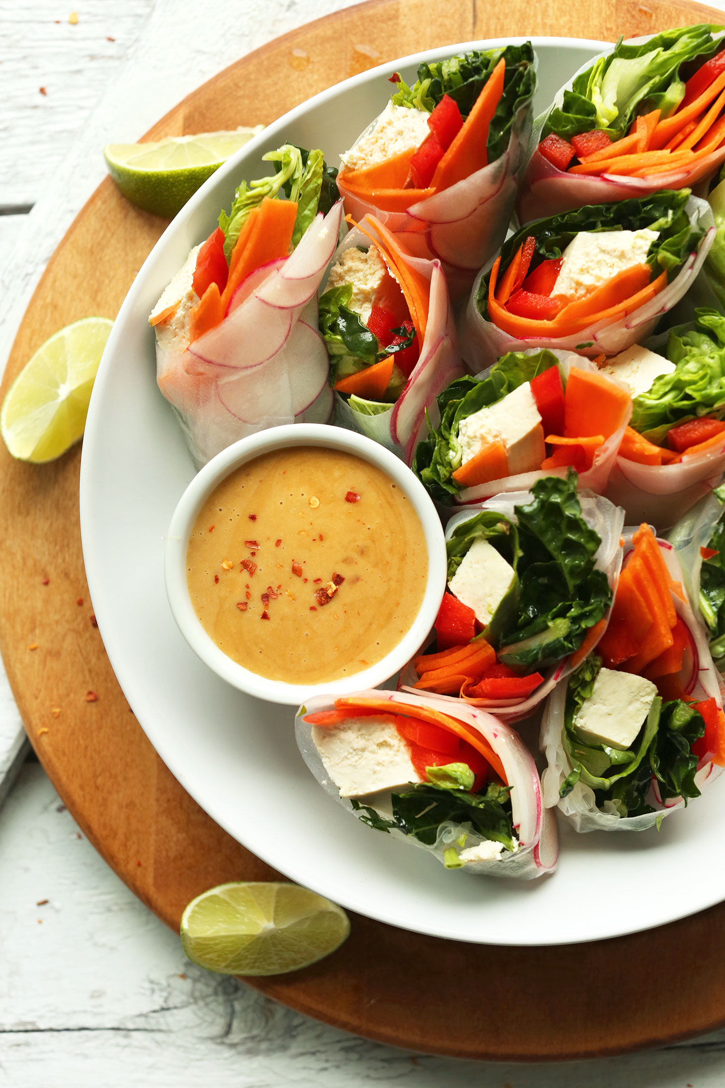 Thai salad rolls arranged in a bowl alongside homemade Cashew Dipping Sauce
