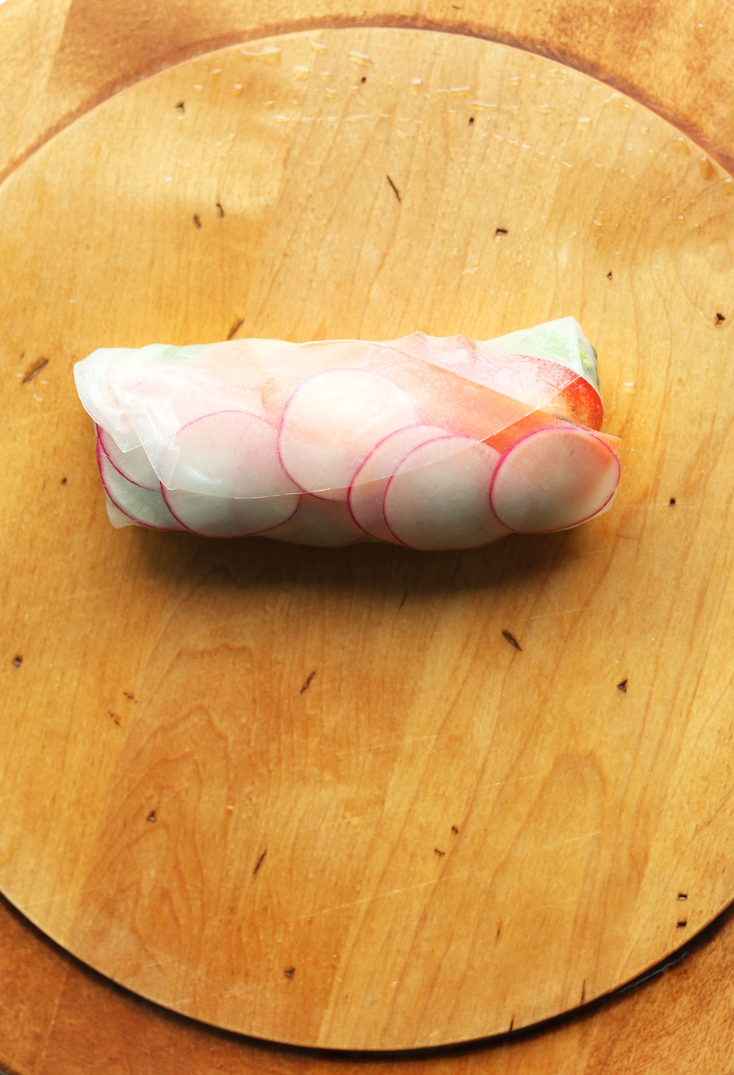 Healthy gluten-free vegan tofu salad roll on a wood cutting board