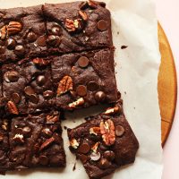 Stack of perfectly cut gluten-free vegan Brownies with pecans and dark chocolate chips