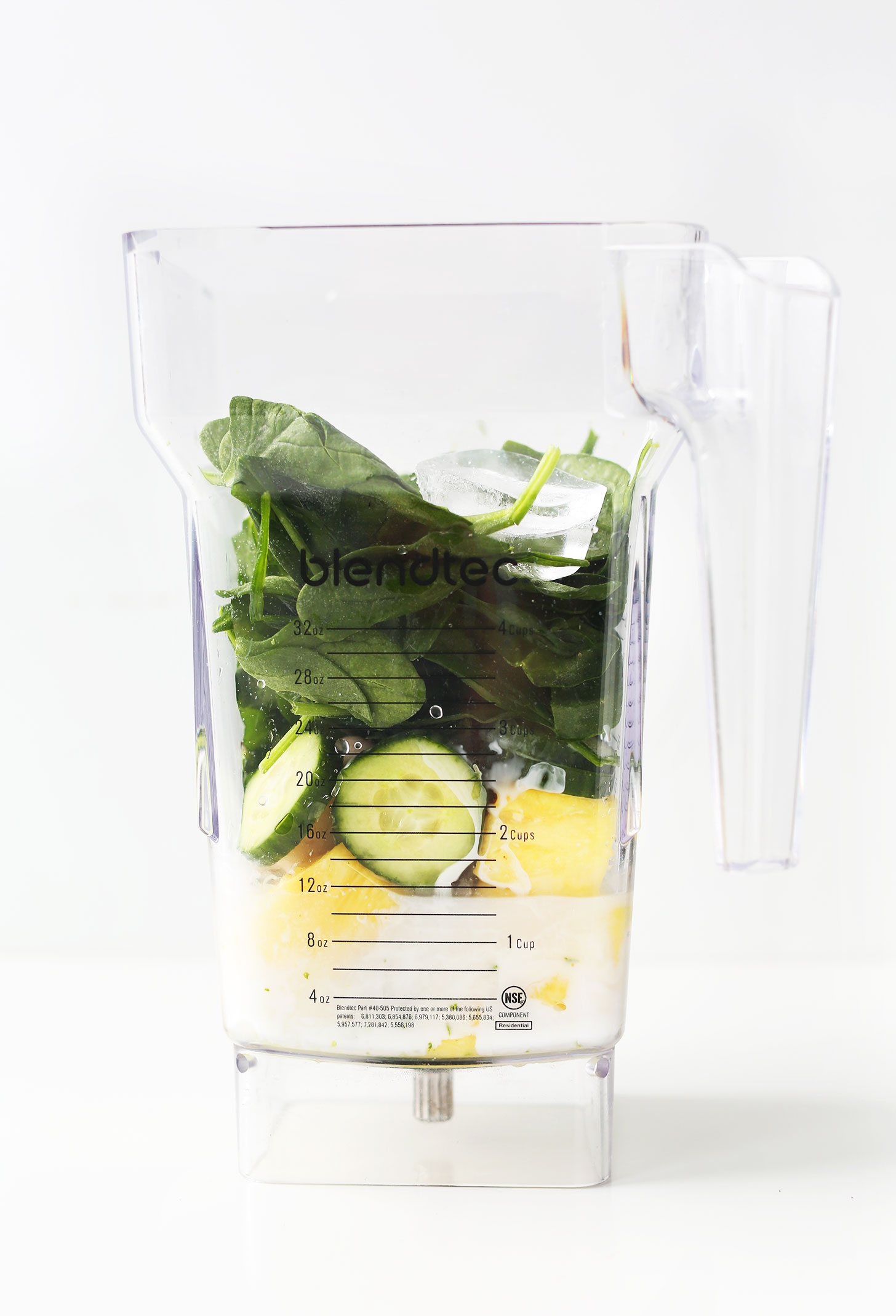 Blender with ingredients for making a Healthy Creamy Cucumber Green Smoothie with Pineapple