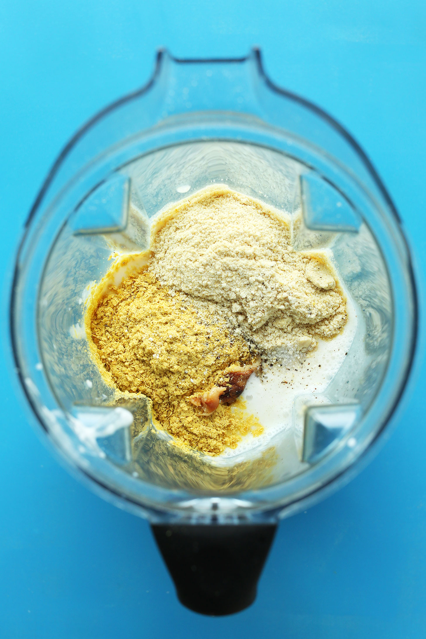 Blender with ingredients for the best vegan mac n cheese sauce