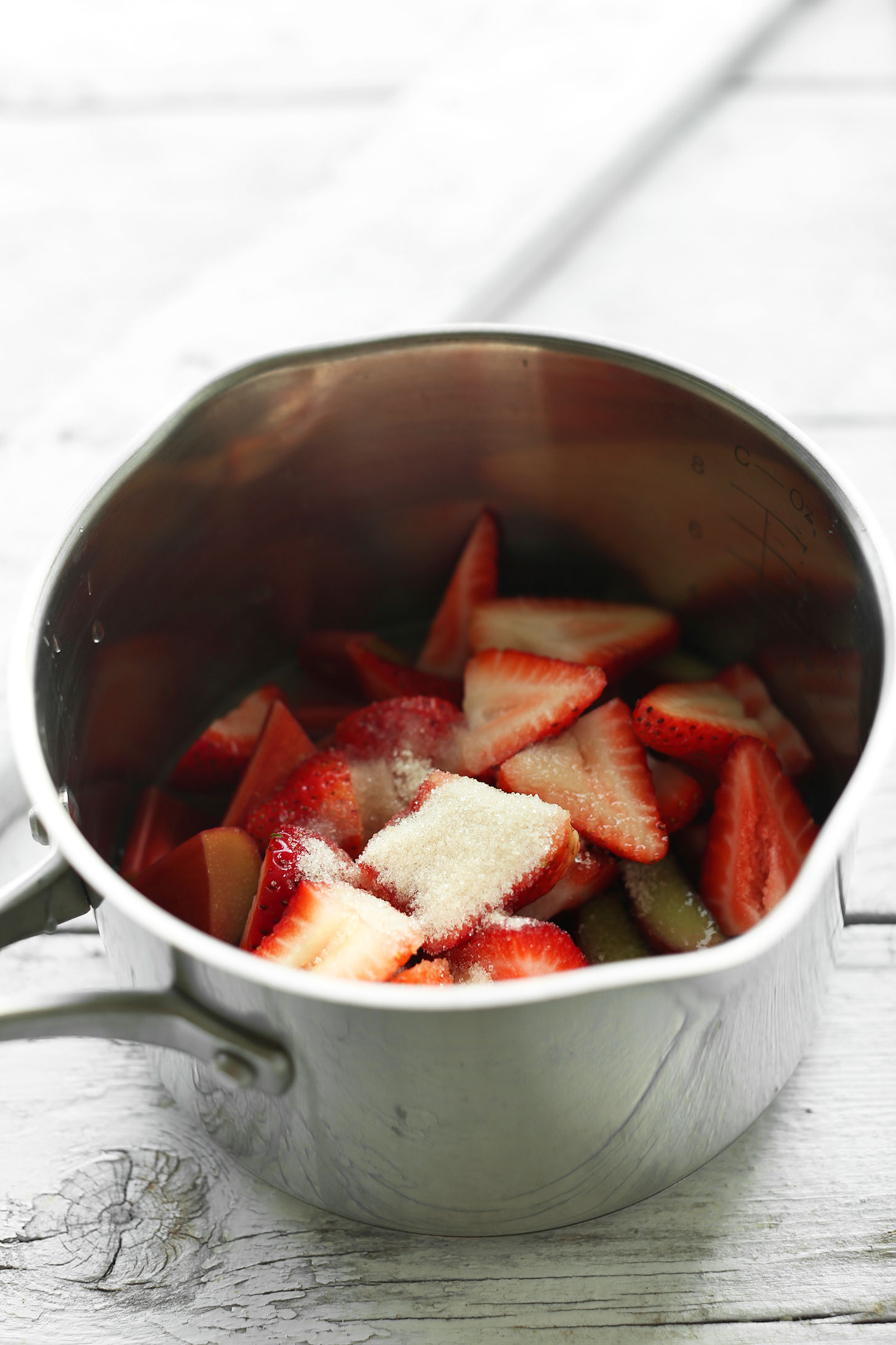 Cooking strawberries, rhubarb, and sugar in a saucepan
