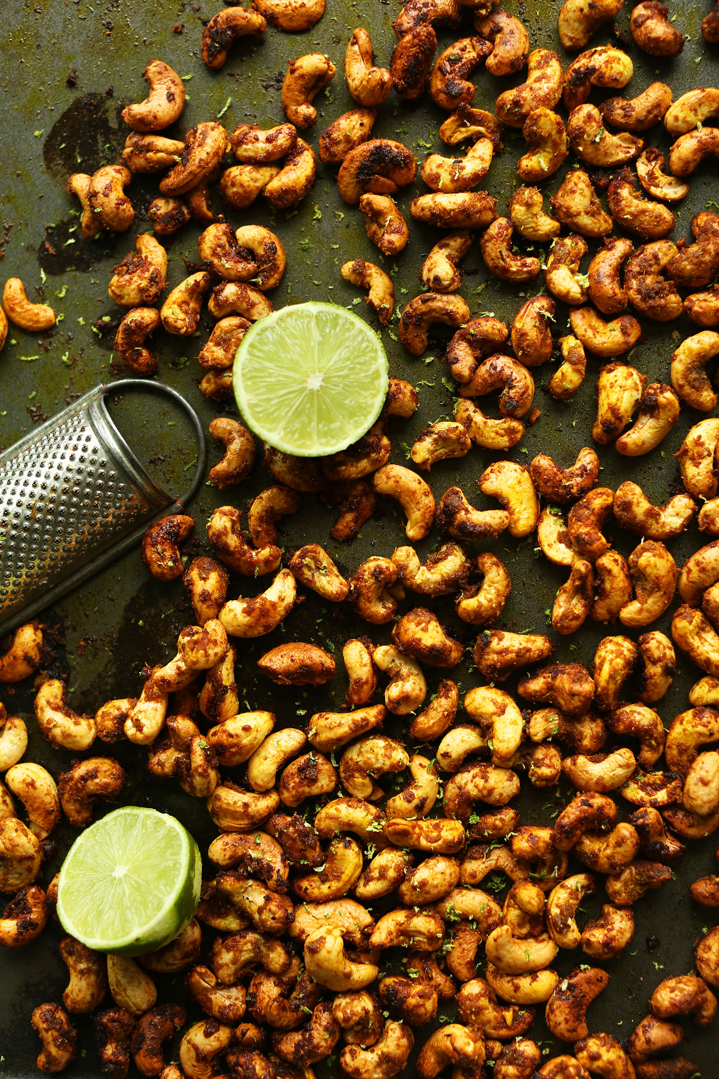 Baking sheet filled with homemade Green Curry-Spiced Cashews for a delicious vegan snack or salad topper