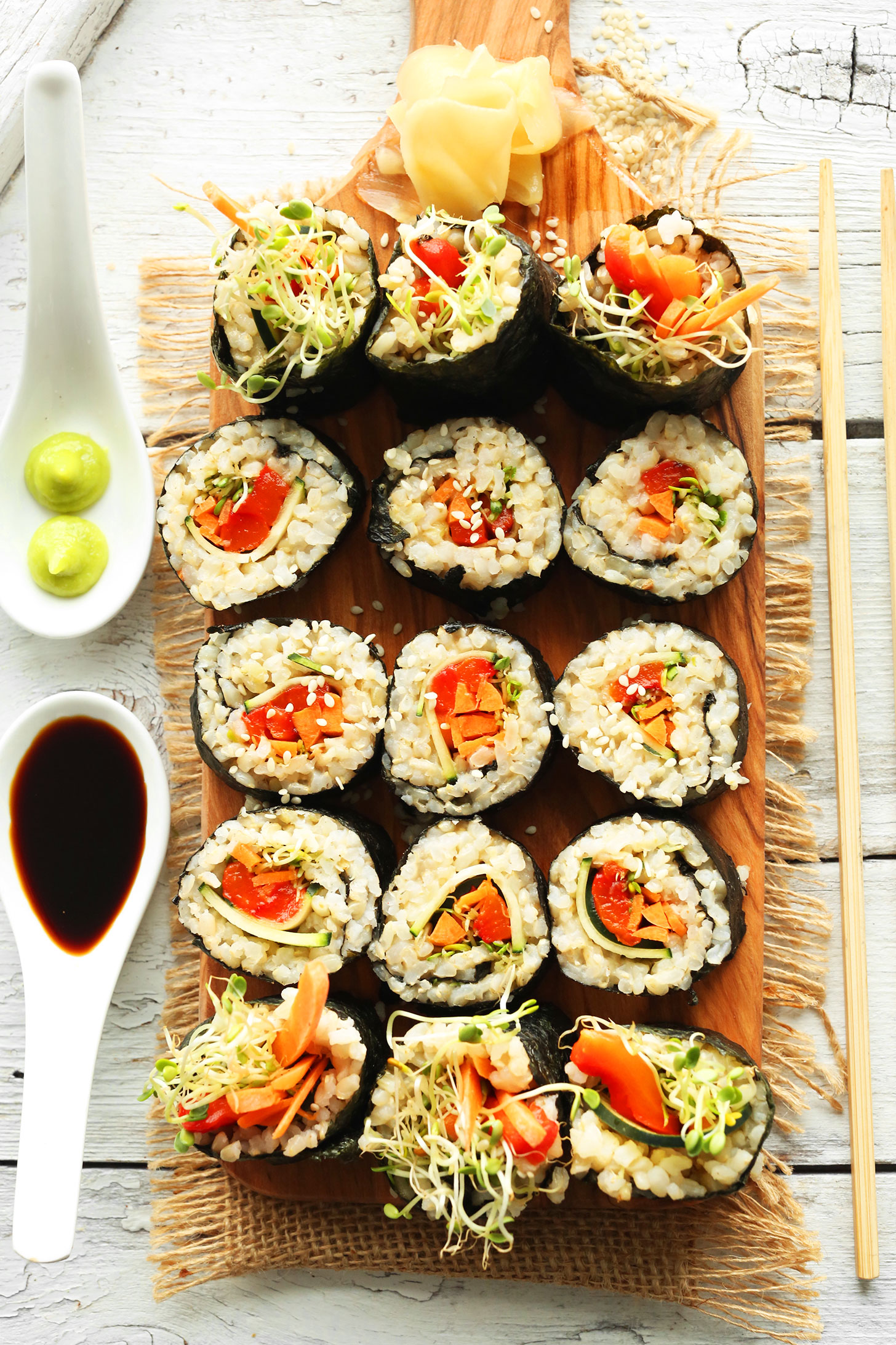 Cutting board filled with rolls of our Vegan Brown Rice Sushi recipe