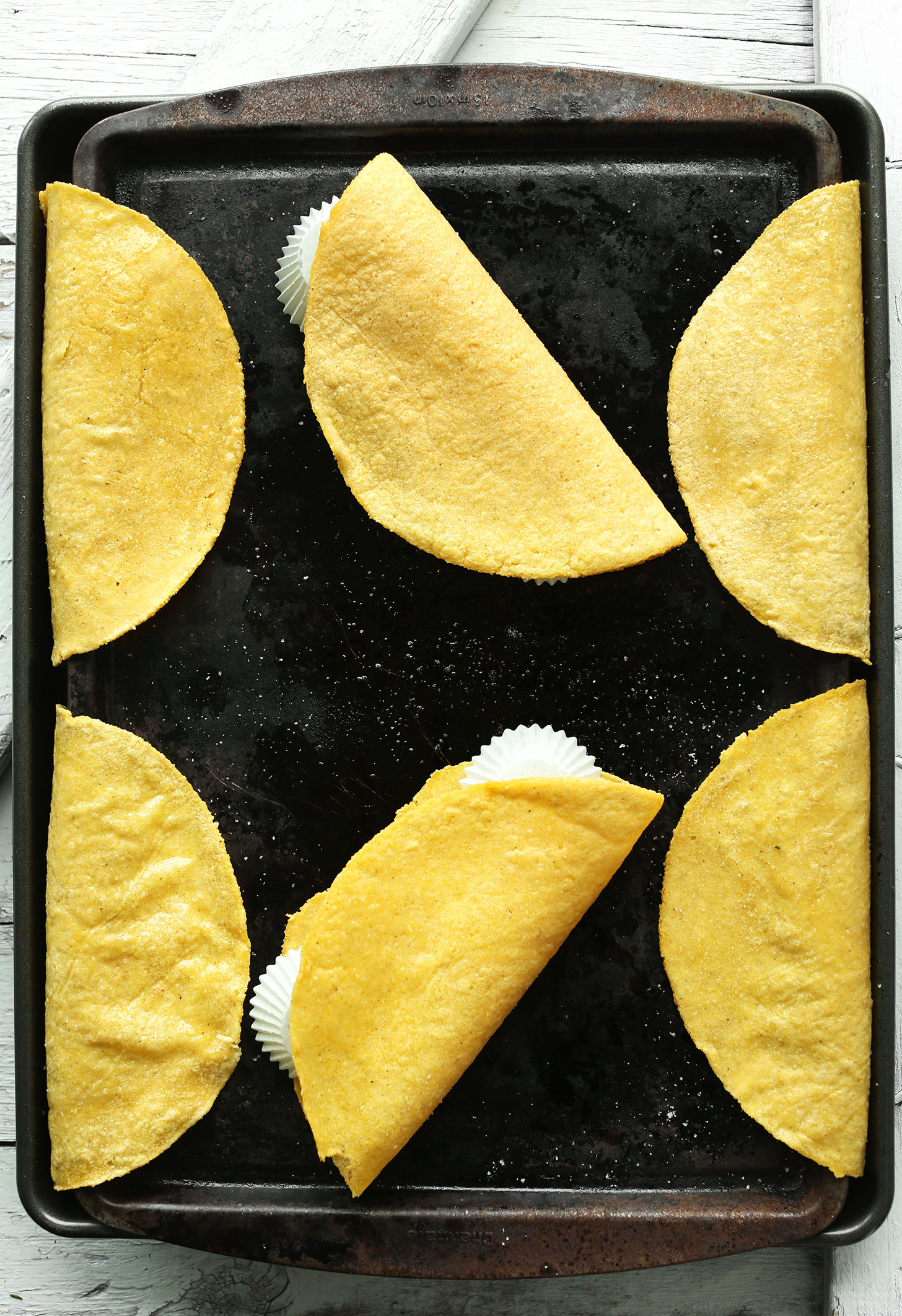 Baking sheet showing how to make homemade Crispy Baked Corn Taco Shells