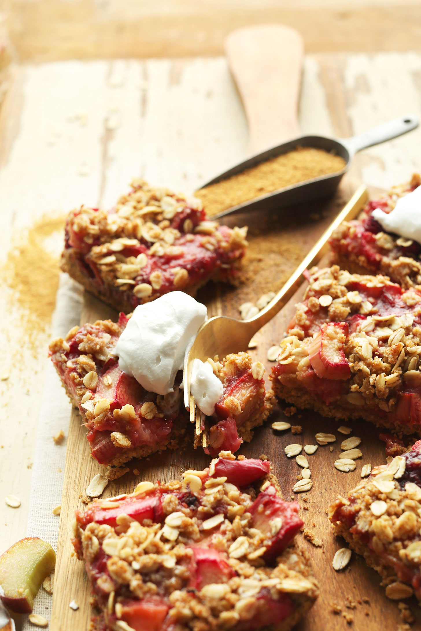 Slicing into a Strawberry Crumble Rhubarb Bar for a delicious gluten-free vegan dessert