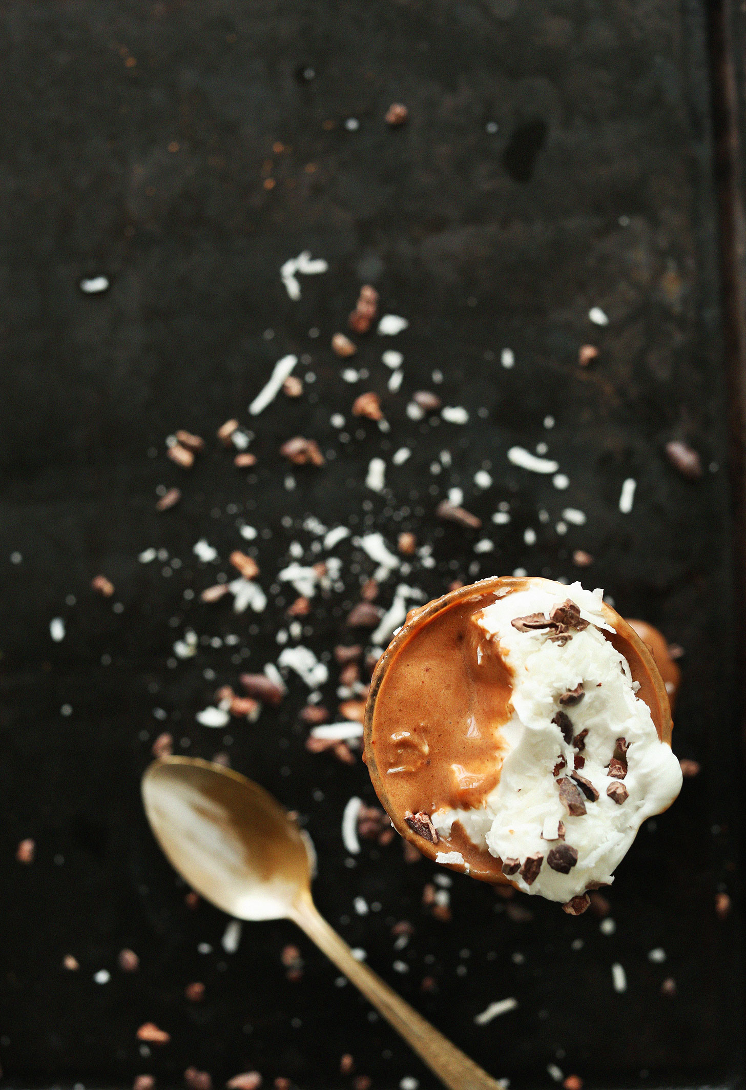Top view of our Banana Split Smoothie topped with coconut whip and cacao nibs