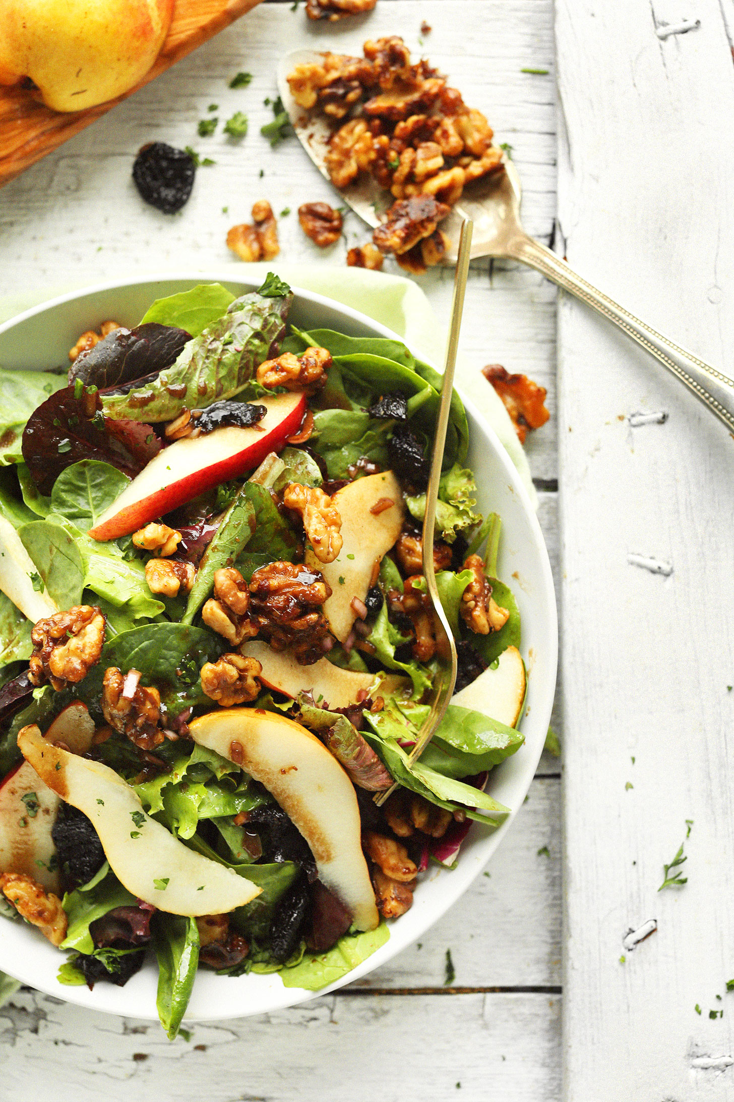 A bowl of our Easy Pear Salad with Dried Cherries and Candied Walnuts for an easy fall salad
