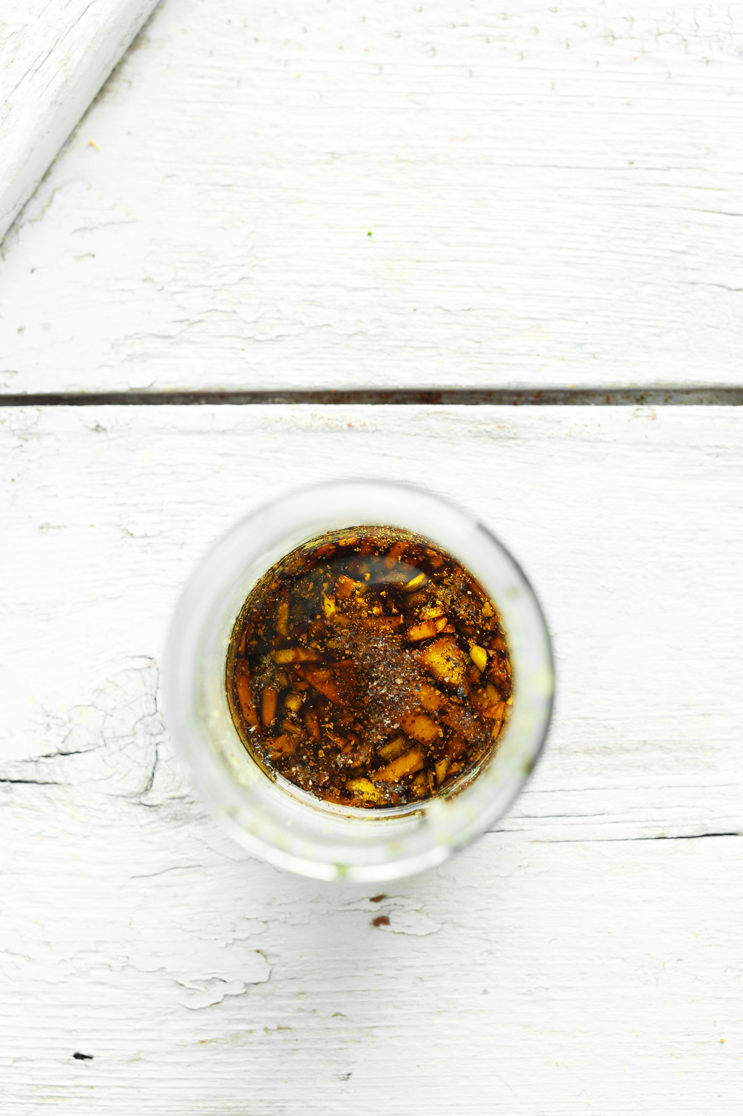 Mason jar with ingredients for making balsamic vinaigrette for our Pear Salad recipe