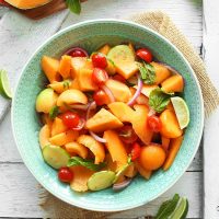 Teal bowl filled with our Summer Tomato, Cucumber, and Cantaloupe Salad