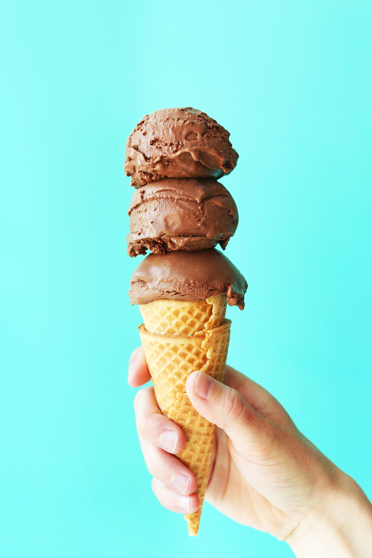 Scoops of homemade vegan chocolate ice cream piled onto gluten-free vegan sugar cones