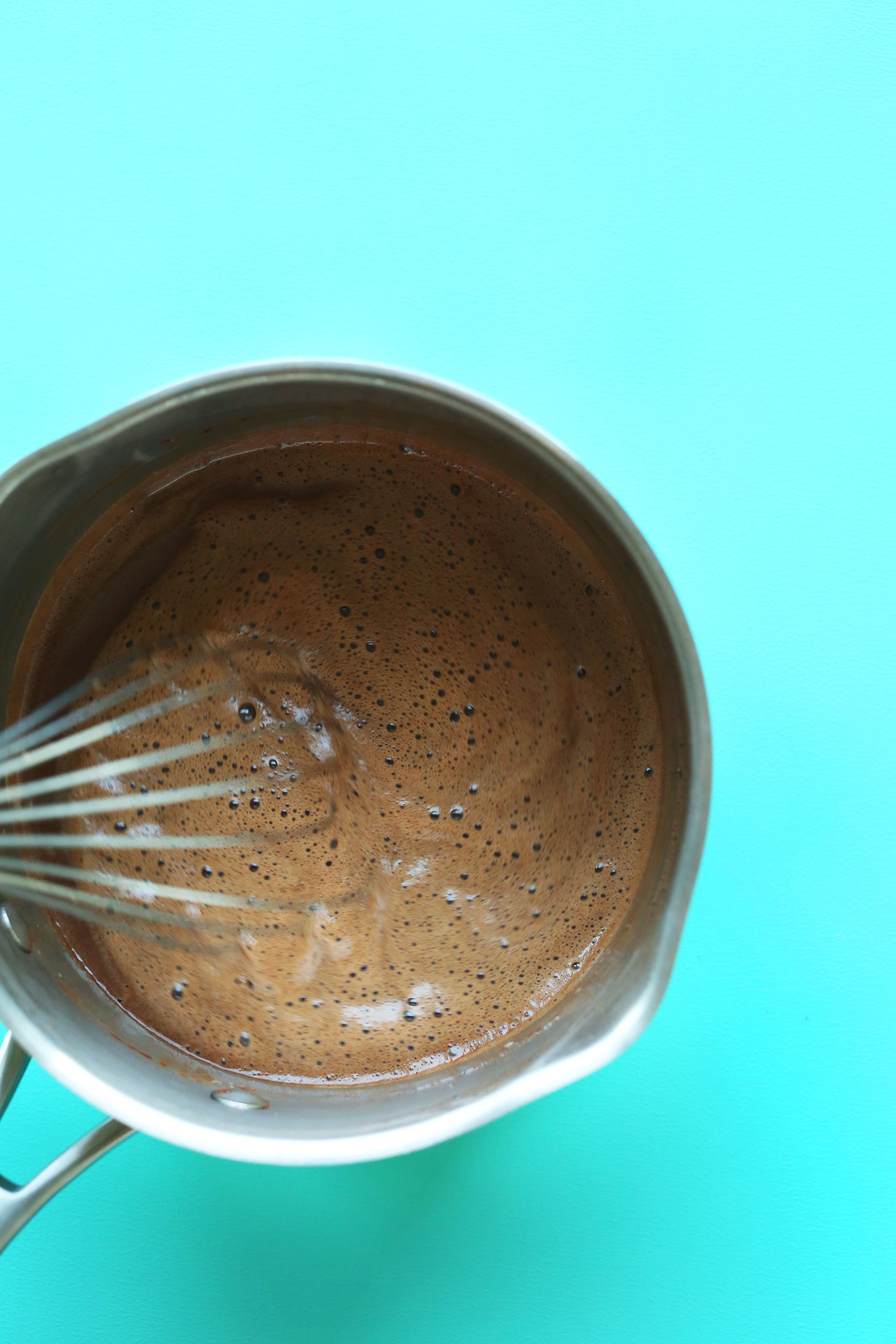 Whisking together chocolate for making vegan chocolate ice cream