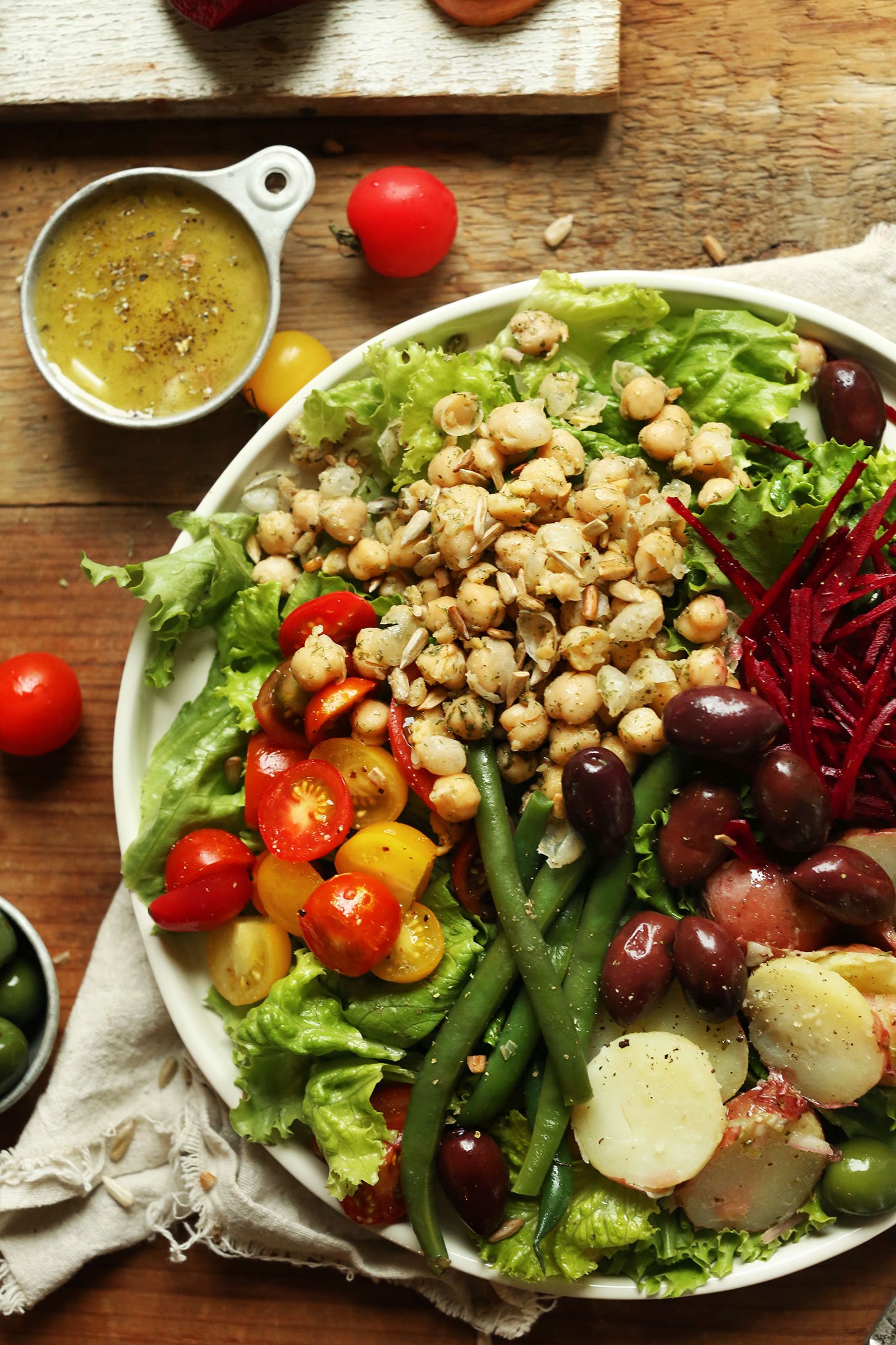 Big serving of our Easy Vegan Nicoise Salad with a side of Shallot and Dijon Vinaigrette