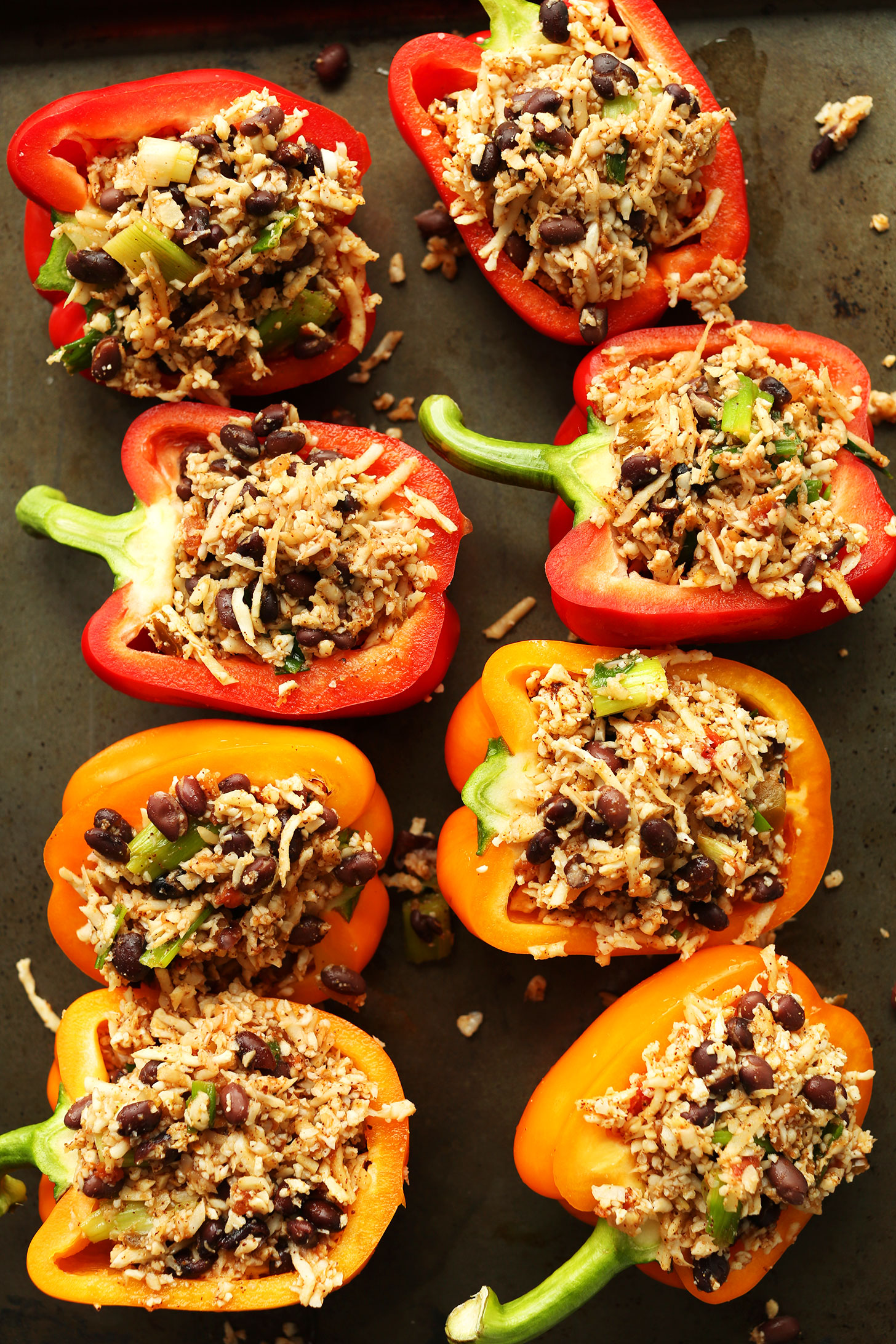 Baking sheet filled with gluten-free vegan Cauliflower Rice Stuffed Peppers