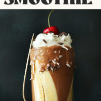 Spoon resting against a glass of our vegan banana split smoothie